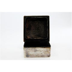 Square silver pill box with raised applications on the hinged lid