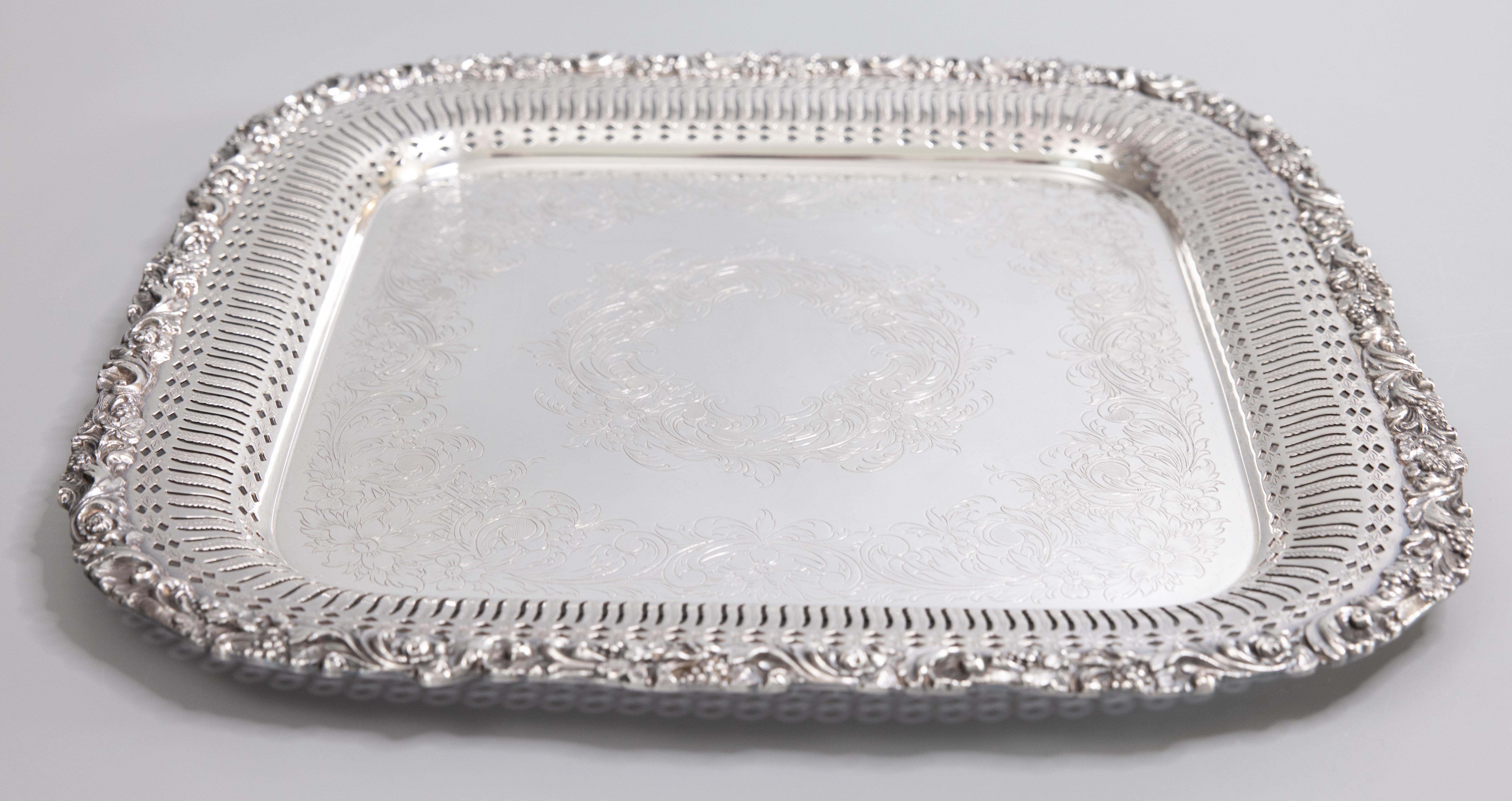 A lovely midcentury silverplate serving tray by International Silver Co. Maker's mark on reverse. This fine quality silver tray is well made and heavy with gorgeous chasing and an ornate scrolling grape vine border. It would be fabulous displayed as