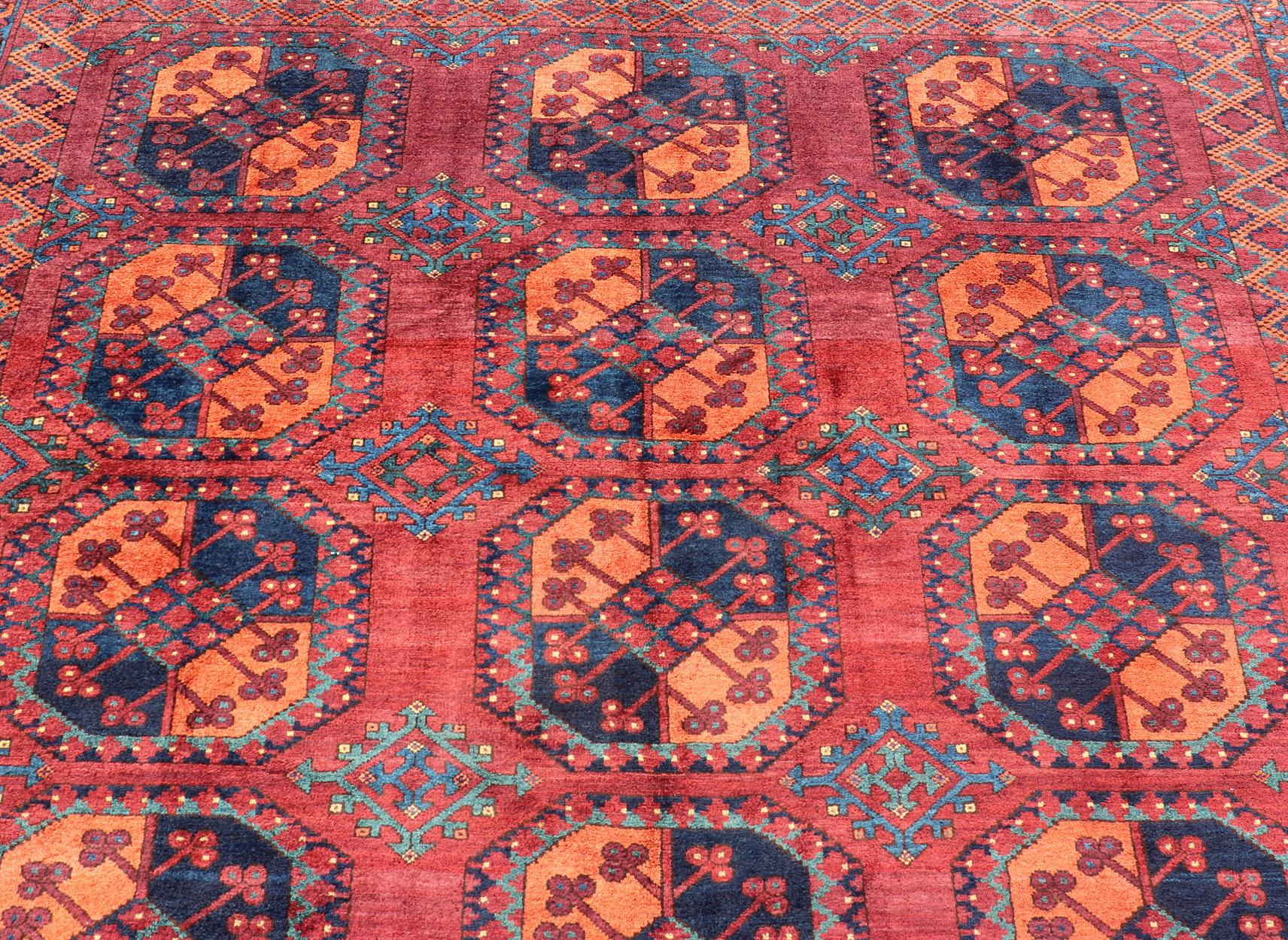 This Turkomen Ersari rug has been hand-knotted in the finest wool. The rug features a repeating sub-geometric Gul design throughout the entirety of the rug, enclosed within a complementary, multi-tiered border, depicting small repeating motifs. The