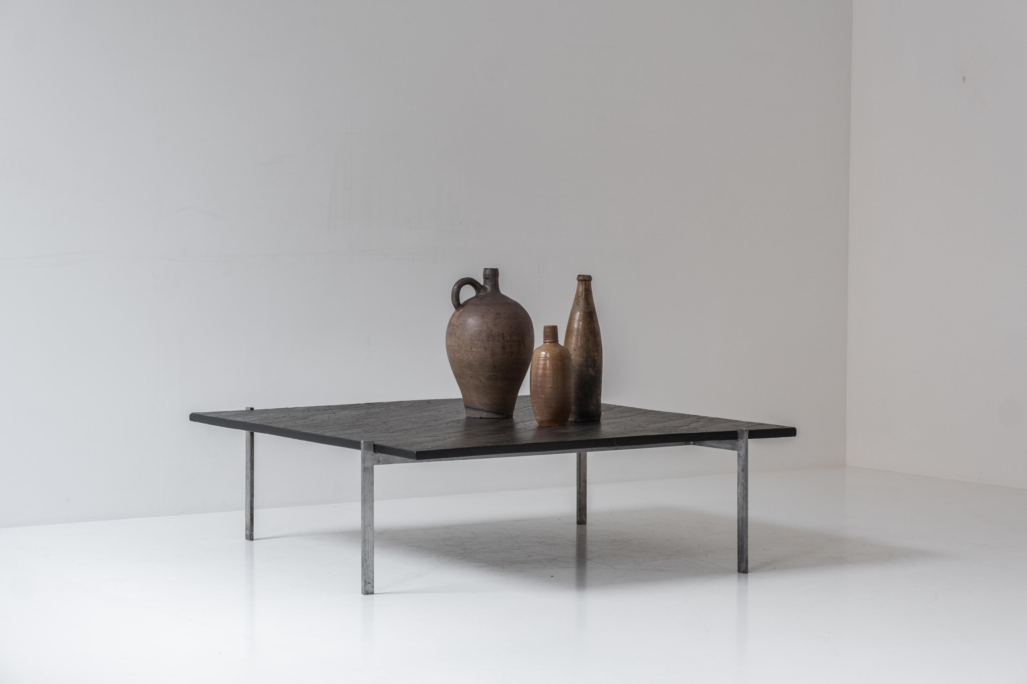 Square slate stone coffee table from the 1950s. The base features a chrome plated steel frame and the top is made out of a black slate stone. This table is similar to the famous PK61 by Poul Kjaerholm, but has other dimensions. Probably a unique