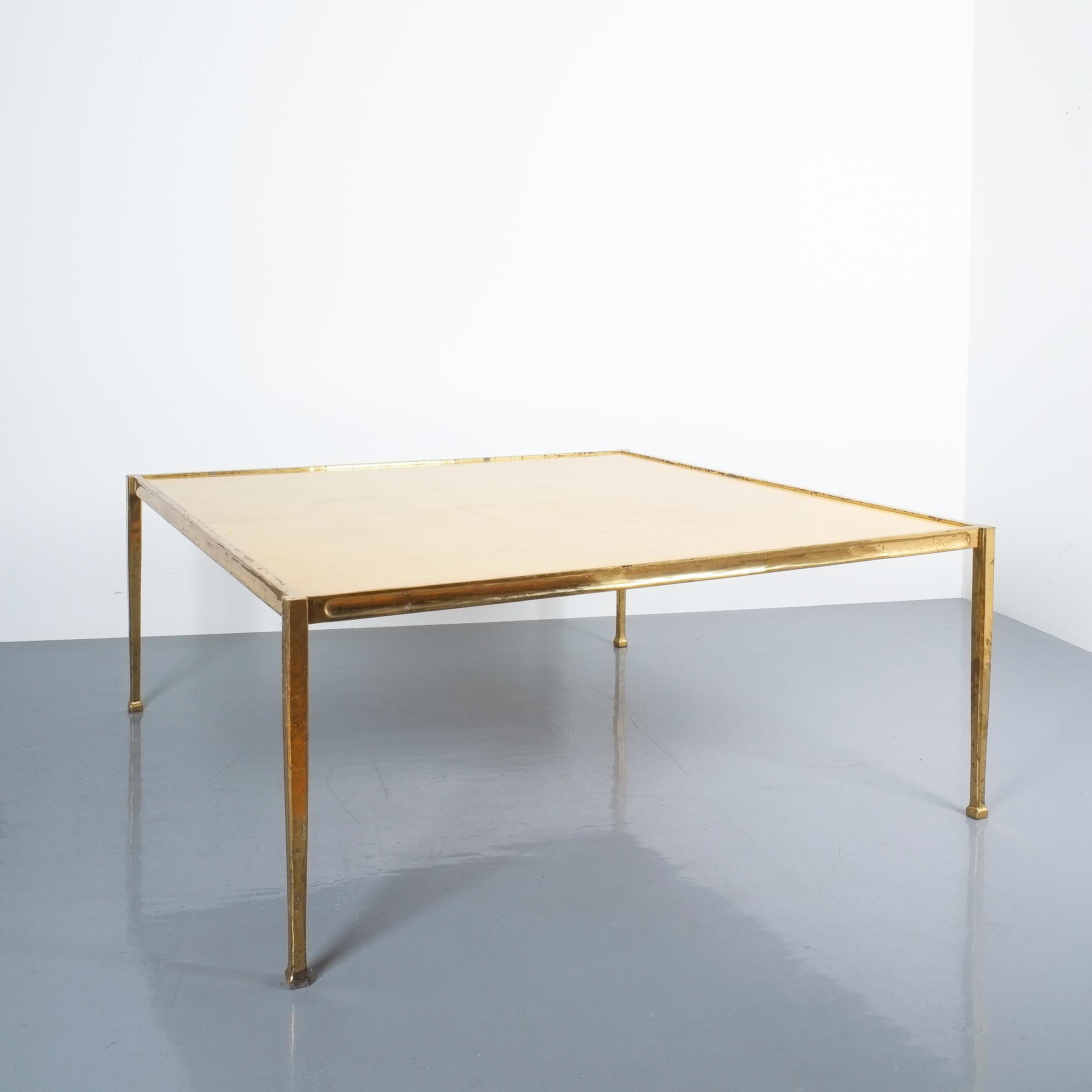 Square large coffee table from solid brass and parchment, France, circa 1965

This elegant table consist of a solid cast brass frame with a large parchment on wood tabletop divided in 4 segments. The brass is beautifully golden patinated, the