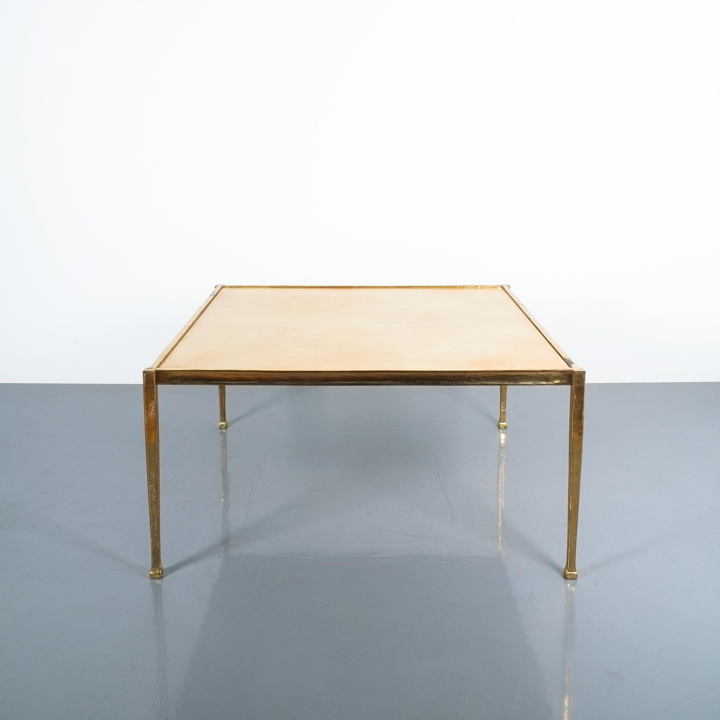 Square large coffee table from solid brass and parchment, France, circa 1965.

Dimensions are 35 x 35 x 17