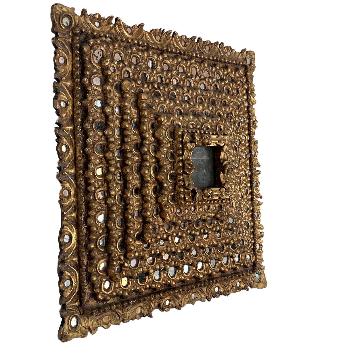 A 19th Century Spanish gilt wood 7-layer mirror with mirror insets in frame and foliage motif along edges.

Measurements:
25