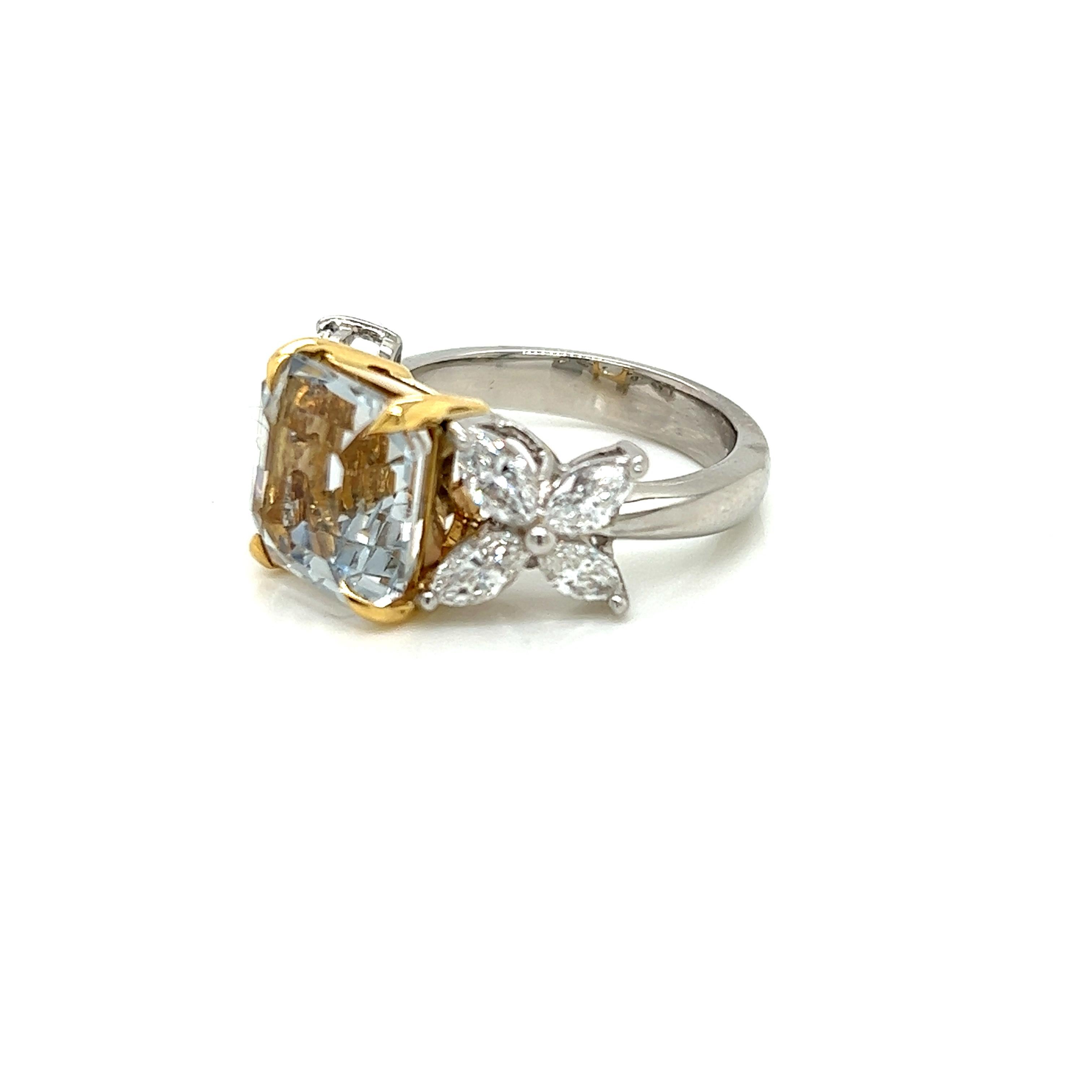 This magnificent Platinum ring features an alluring 5.53 carat Aquamarine set in 18K Yellow Gold at its centre. On either side of it, arranged like dainty, iridescent petals on a flower, are 4 marquise cut Diamonds.

The pristine square-step cut