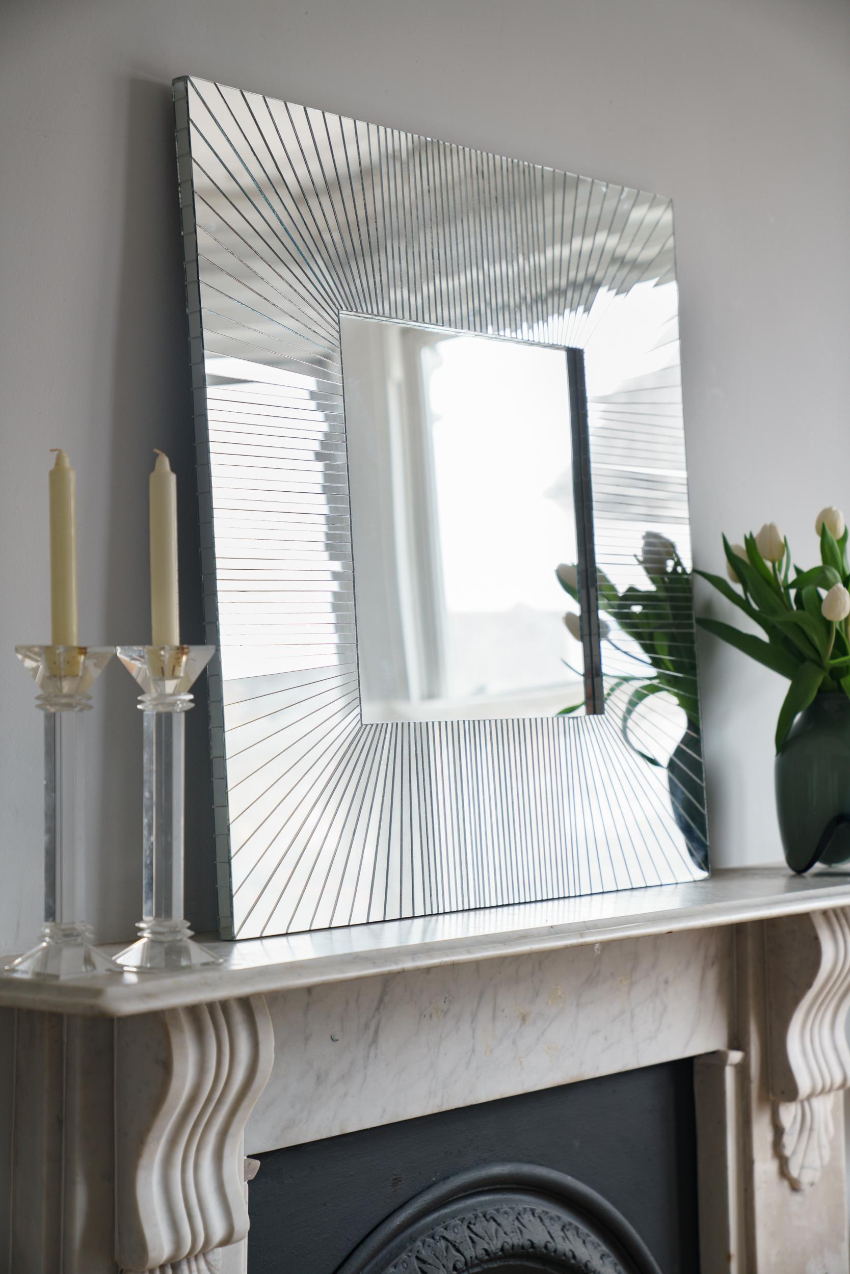 Square Ray Collection Mosaic sunray mirror. This contemporary mosaic mirror is handmade in the UK by Claire Nayman. Each piece of mirror is individually handcut and reflects the light beautifully. The base of the mirror is made of MDF. The central