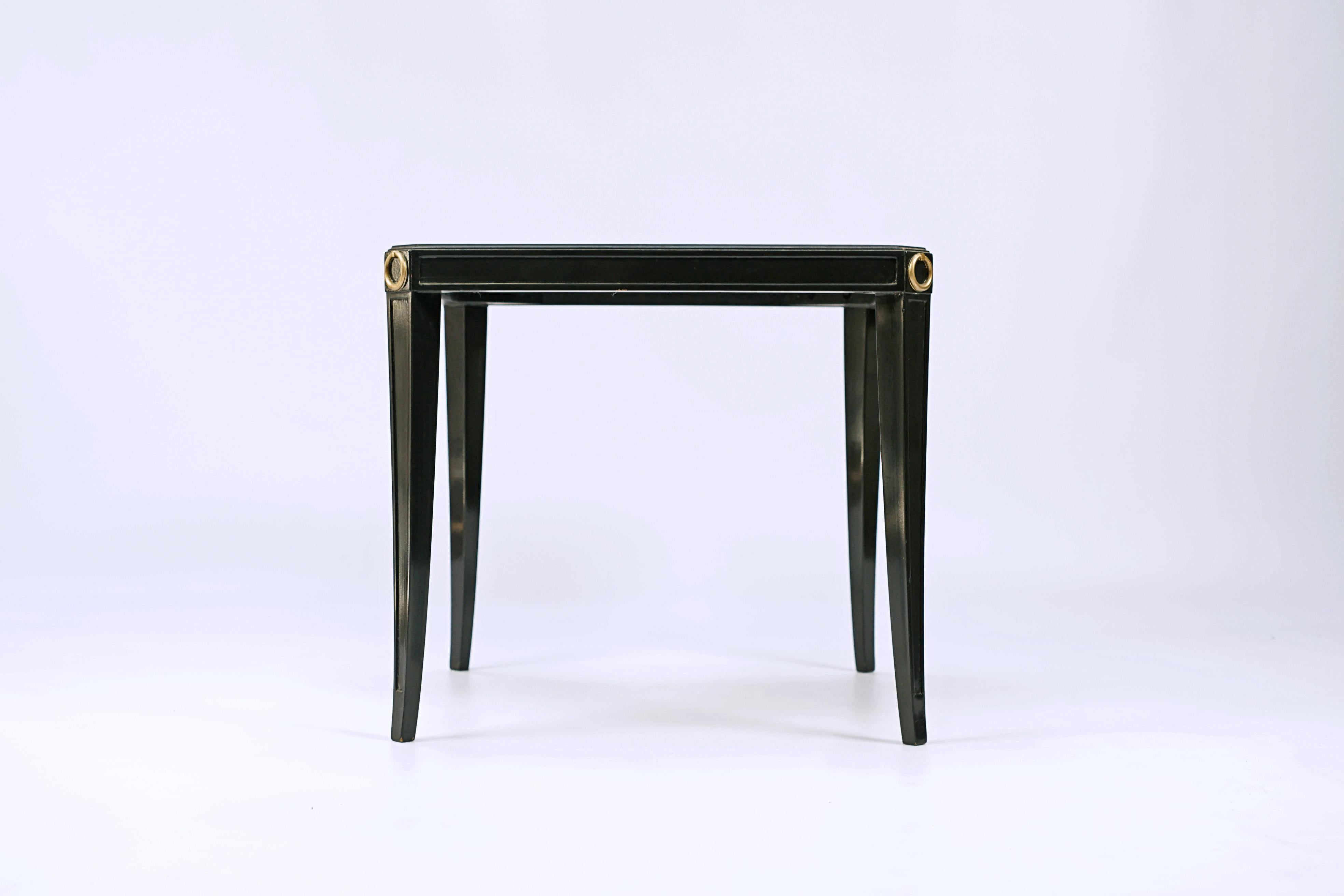 Square table designed by Andre Arbus (1903-1996).  Black gloss finish with golden bronze details.

France, CIRCA 1940.