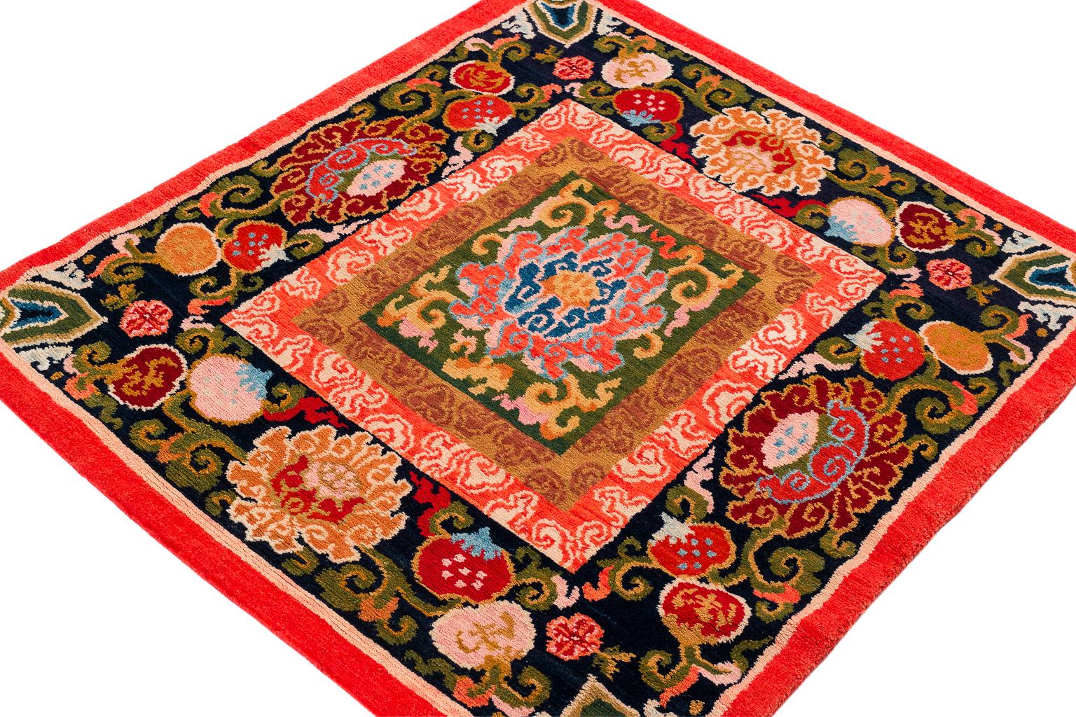 This spectacular reproduction of a small antique Tibetan mat was made with 100% vegetable dyes and made using authentic Tibetan weaving techniques. The carpet is 100% Himalayan wool and woven in a beautiful black and red color scheme with