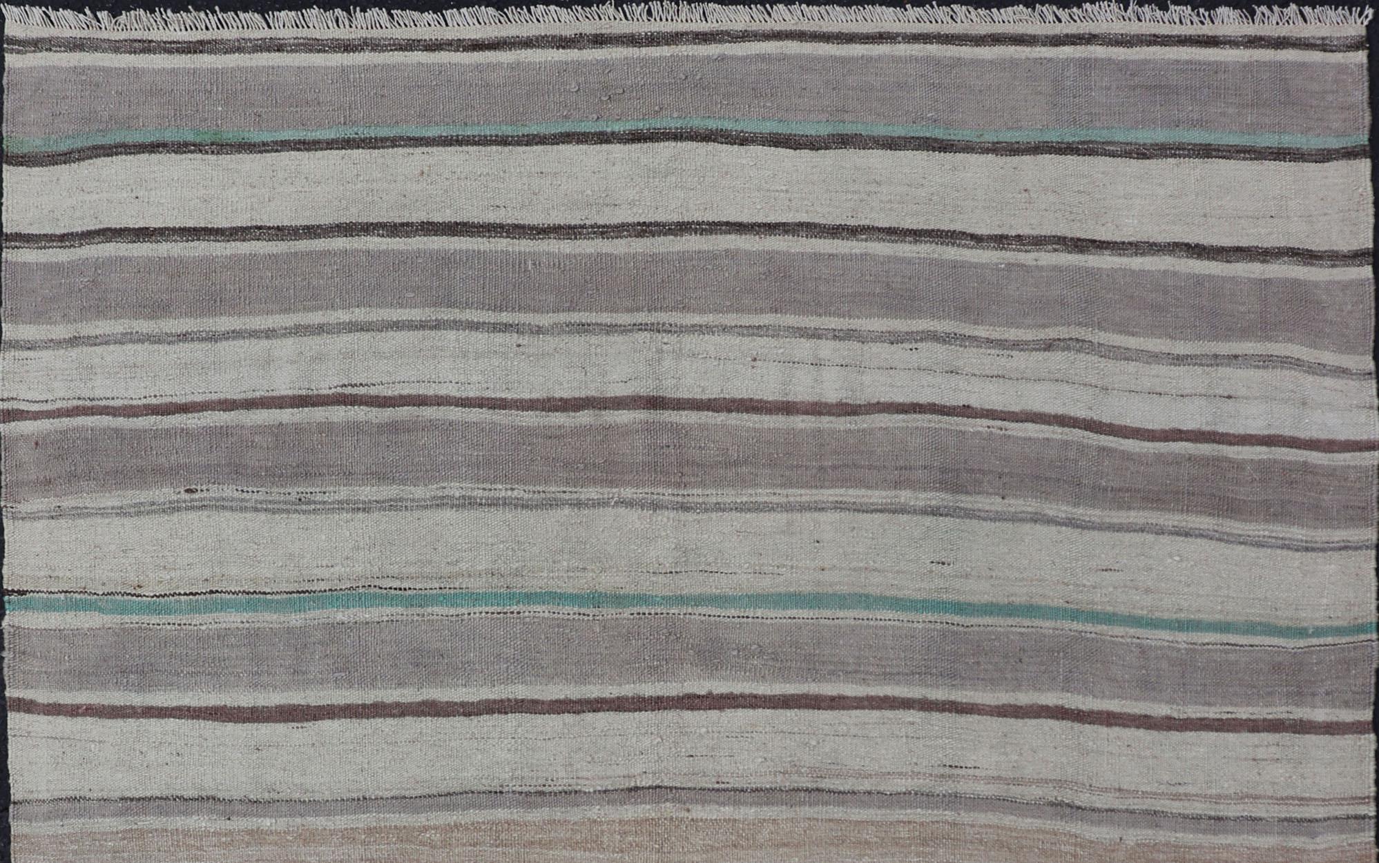 Turkish vintage Kilim flat-weave small rug in brown, lavender, and cream with stripe design, with Minimalist design and stripes. Keivan Woven Arts / rug EN-178769, country of origin / type: Turkey / Kilim, circa 1950
Measures:4'7 x 5'0 

This