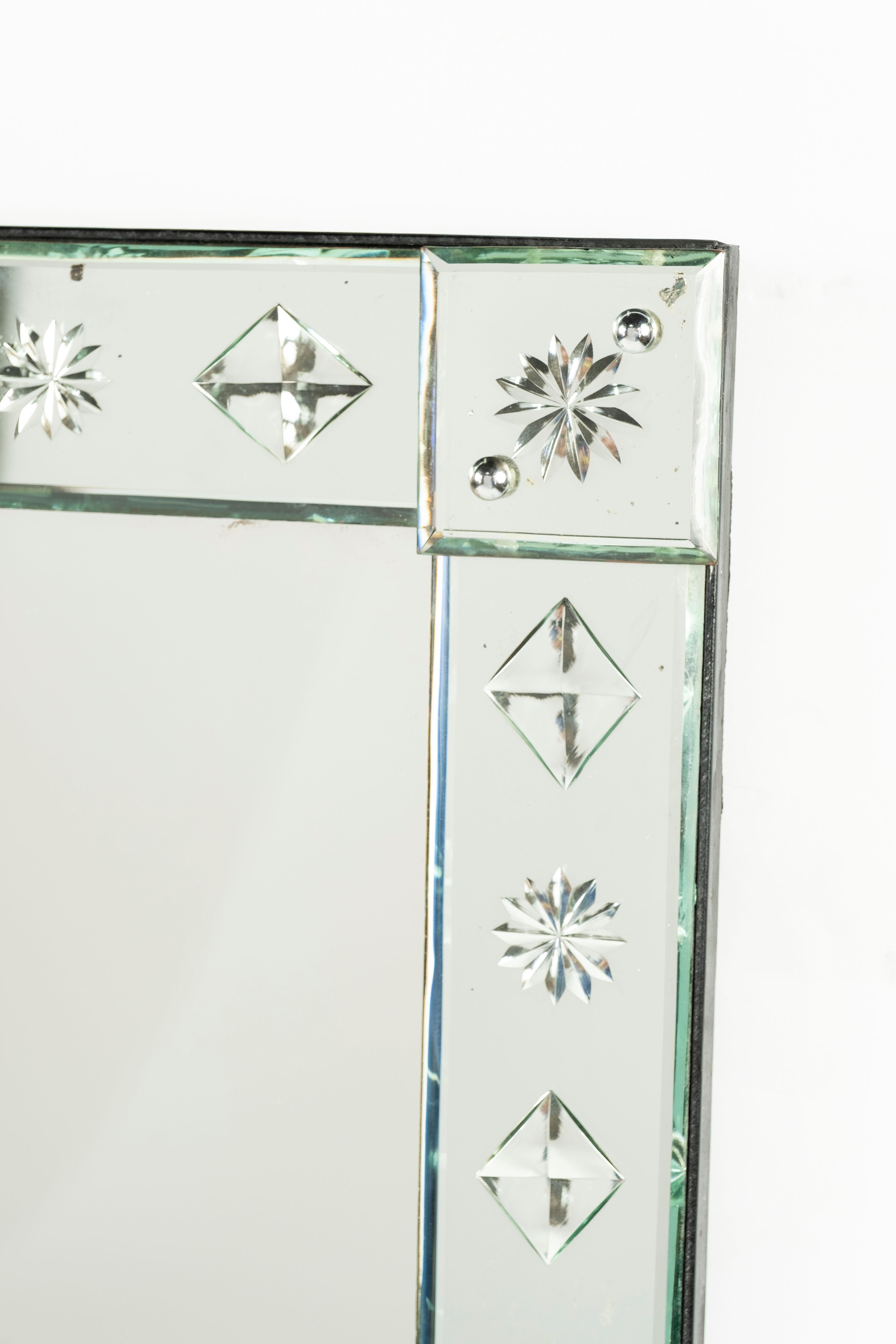 A Venetian frame wall mirror, - the square mirror plate with star and lozenge cut borders. Likely from a Bistro in France.