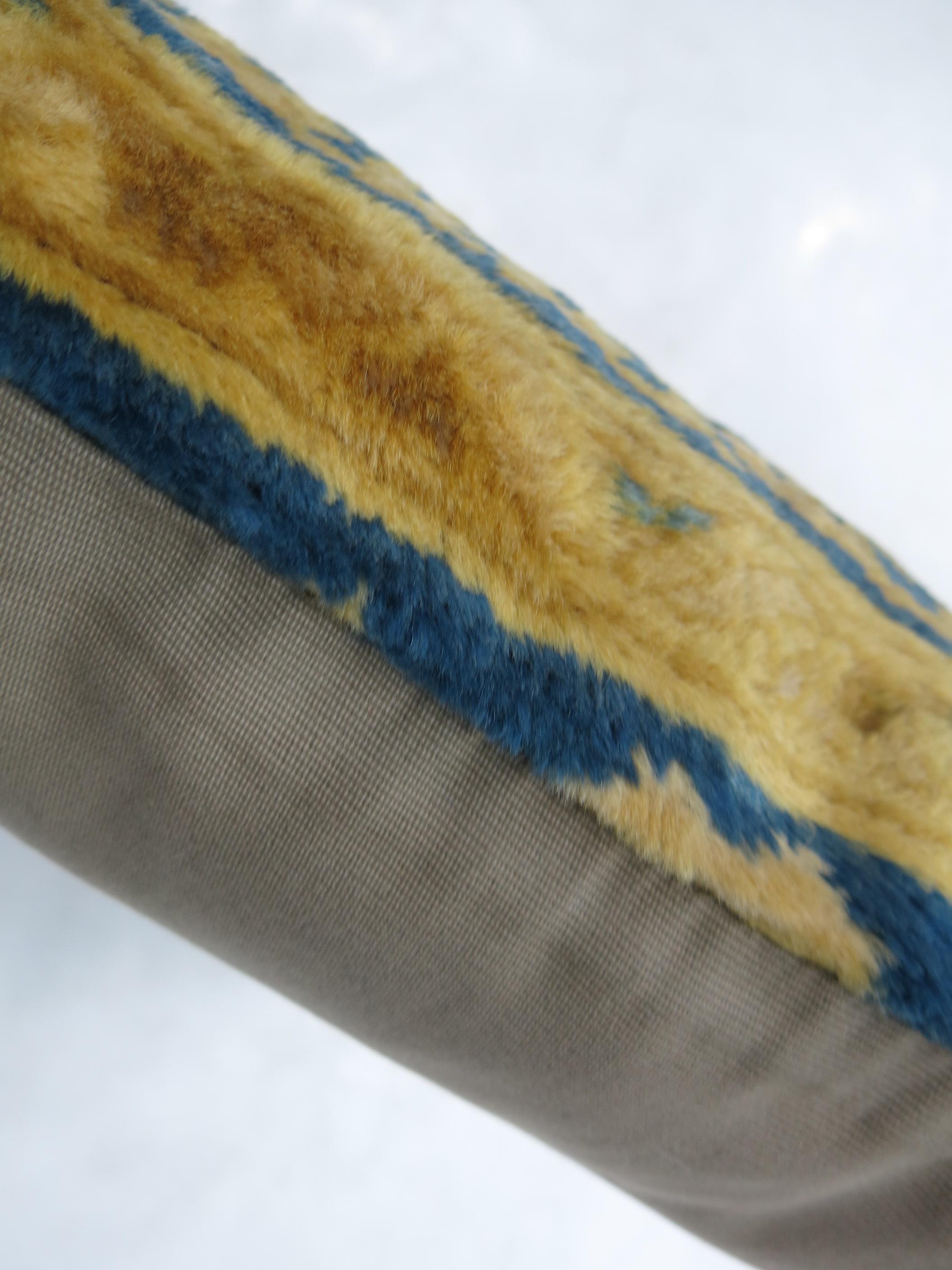 Pillow made from a 20th-century Indian larestan rug with silky wool in blues and gold.

Measures: 16'' x 16''.