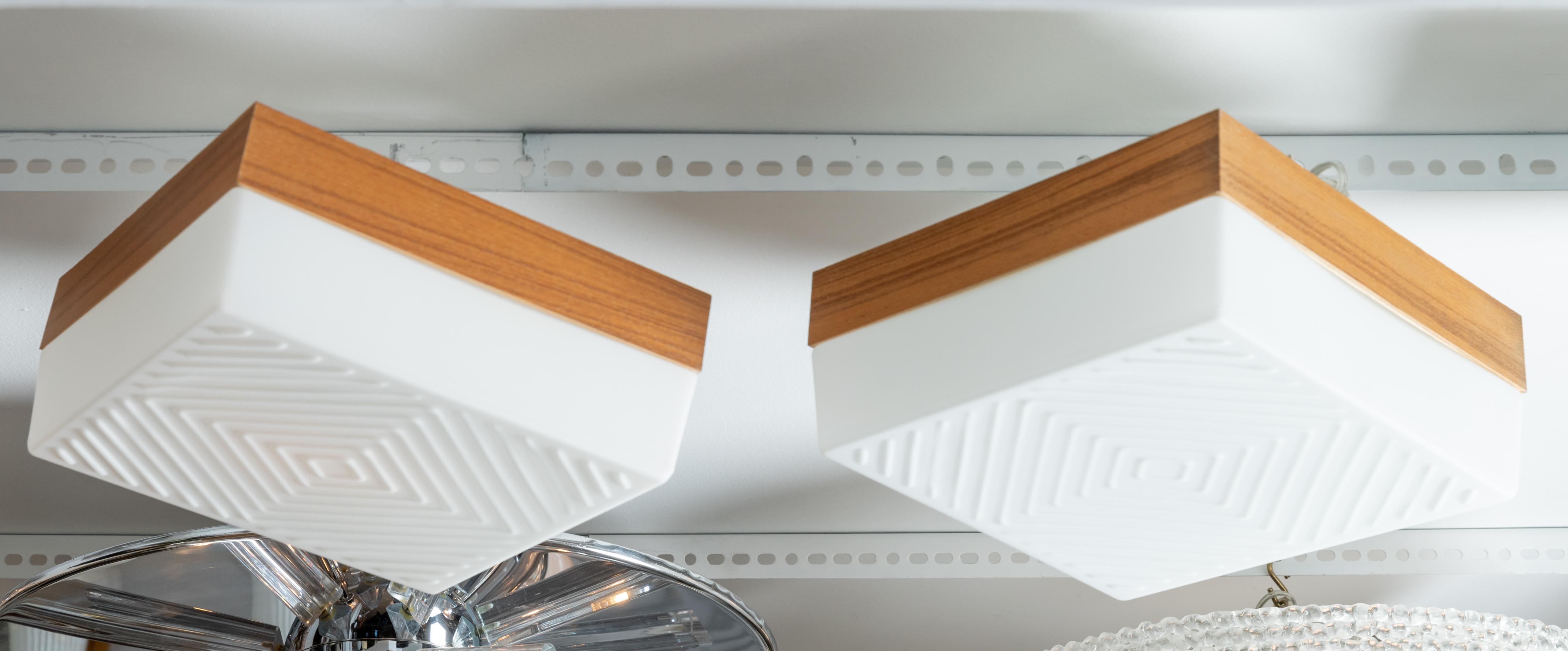 Square white glass flush mount with wood collar and diamond pattern.