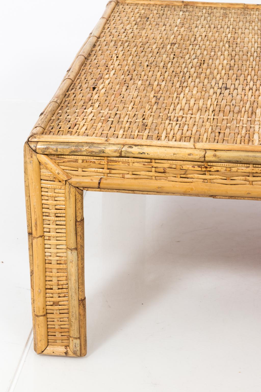 Square woven rattan coffee table wrapped around a solid wood frame, circa mid-20th century.
 
