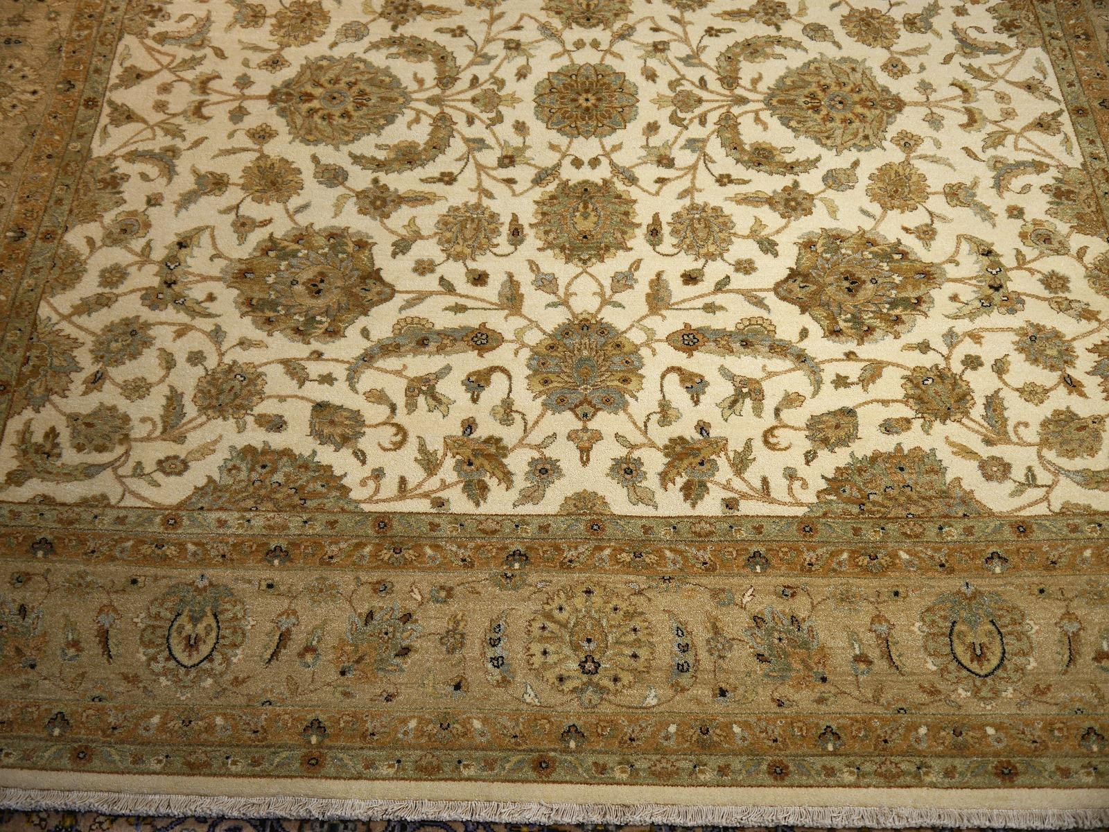 A beautiful square contemporary design carpet, hand knotted using finest wool. On a light crème field, the design of Lotus blossoms standing next to each other executed in green tones. 
Design Influences are from Persian Tabriz and antique Ziegler