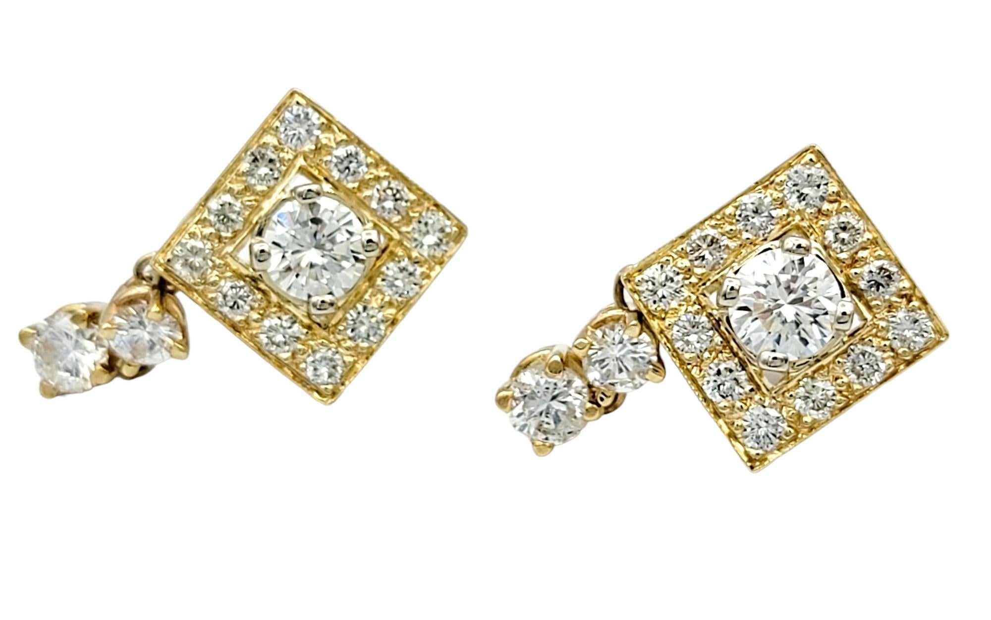 These 14 karat yellow gold earrings are a stunning embodiment of modern elegance and timeless beauty. Each earring features a central round diamond, which serves as the radiant focal point. Surrounding this brilliant centerpiece is a unique squared