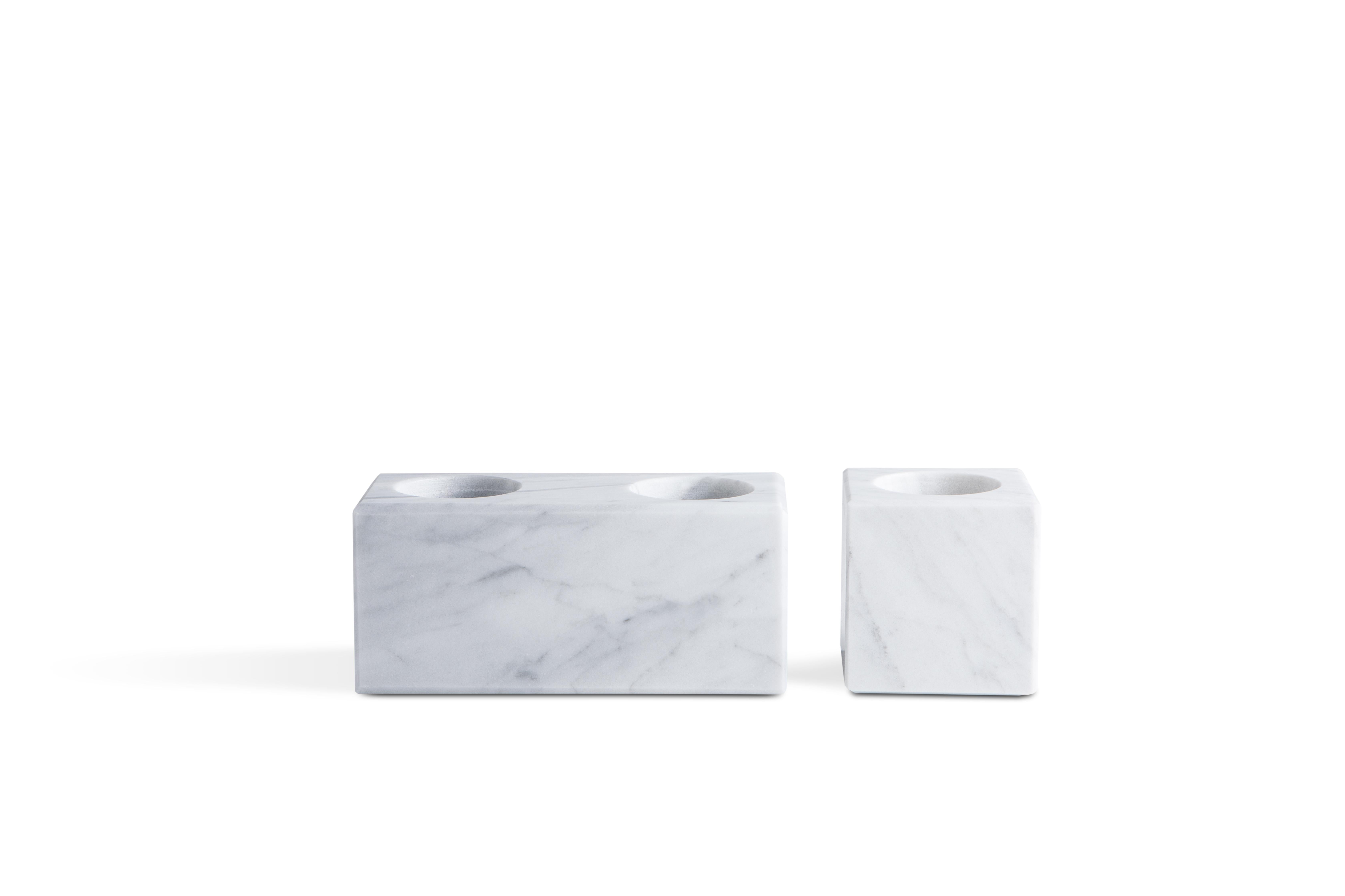 Squared double candleholder in white Carrara marble. 

Each piece is in a way unique (since each marble block is different in veins and shades) and handcrafted in Italy. Slight variations in shape, color and size are to be considered a guarantee