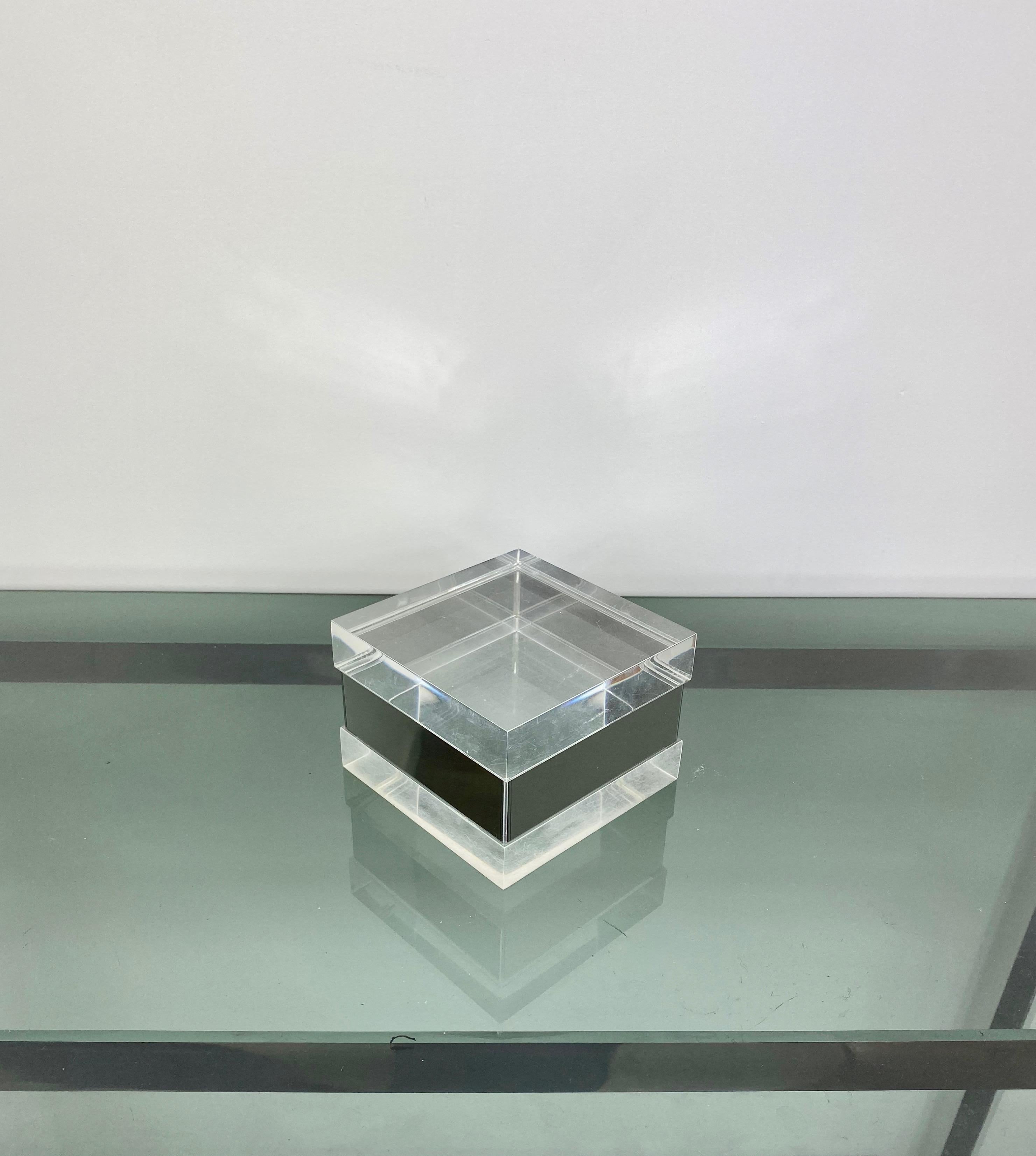 Squared box made in Lucite and with chrome details.