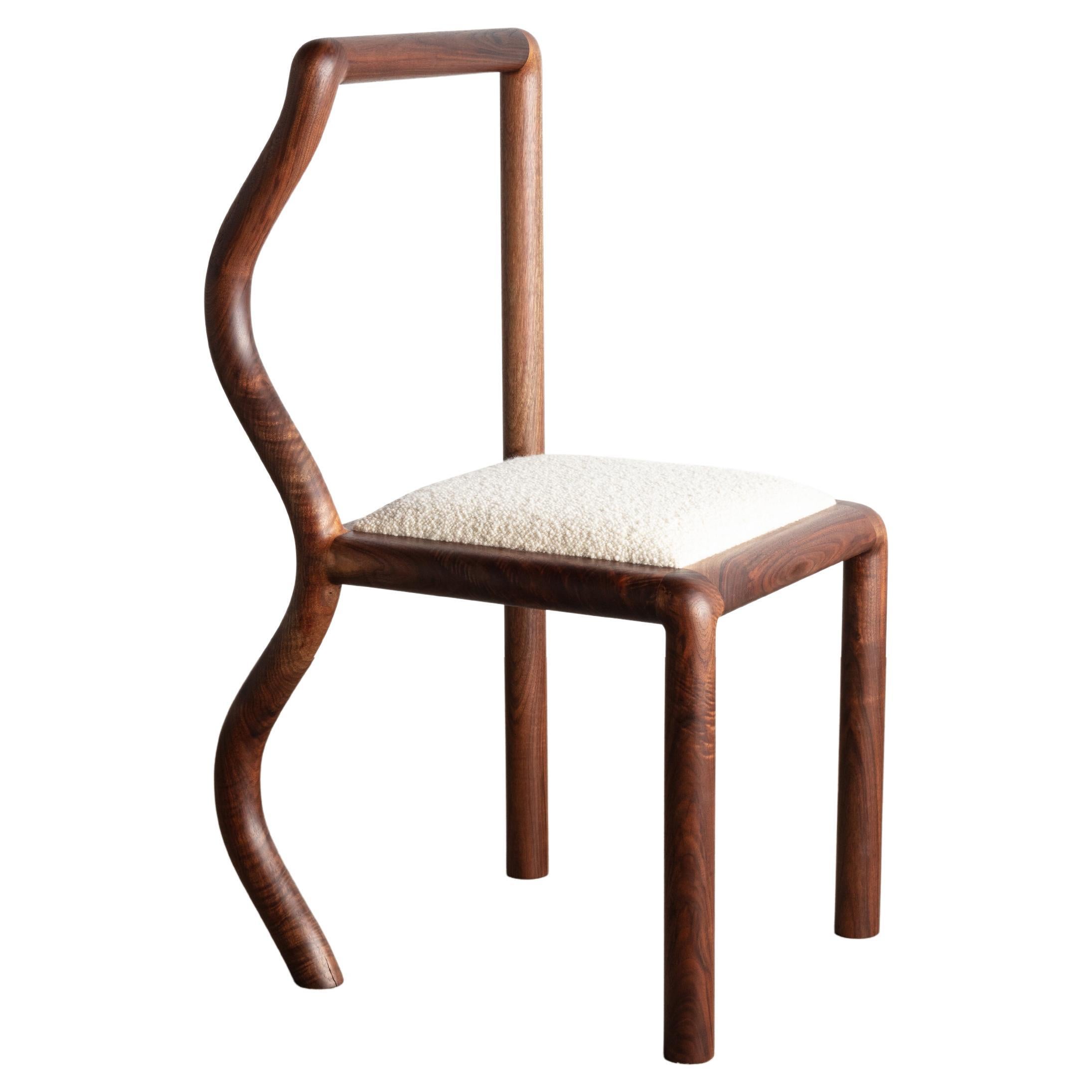 The Squiggle Chair was created though an exploration of shaping solid walnut slab lumber. Designed to bring a smile to any space, each chair part is thoughtfully selected to highlight the grain pattern and characteristics of American black walnut.