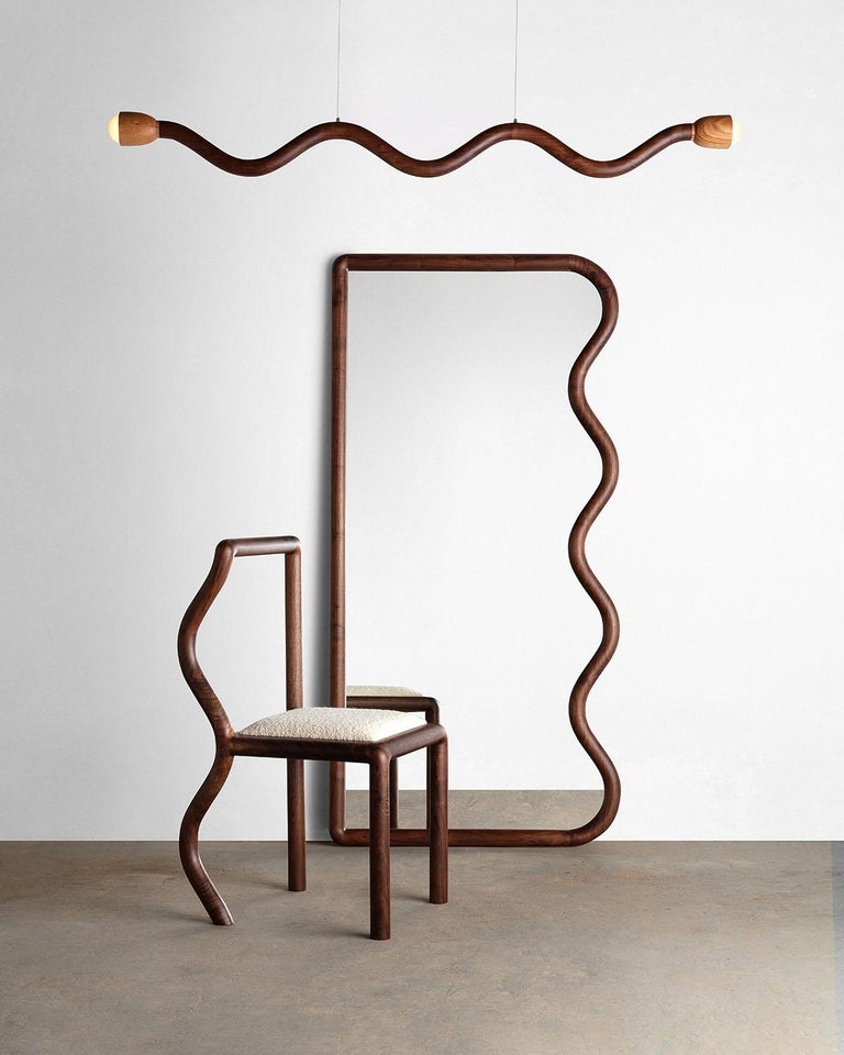 The Squiggle Chair was created though an exploration of shaping solid walnut slab lumber. Designed to bring a sense of humor to any space, each chair part is thoughtfully selected to highlight the grain pattern and characteristics of American black