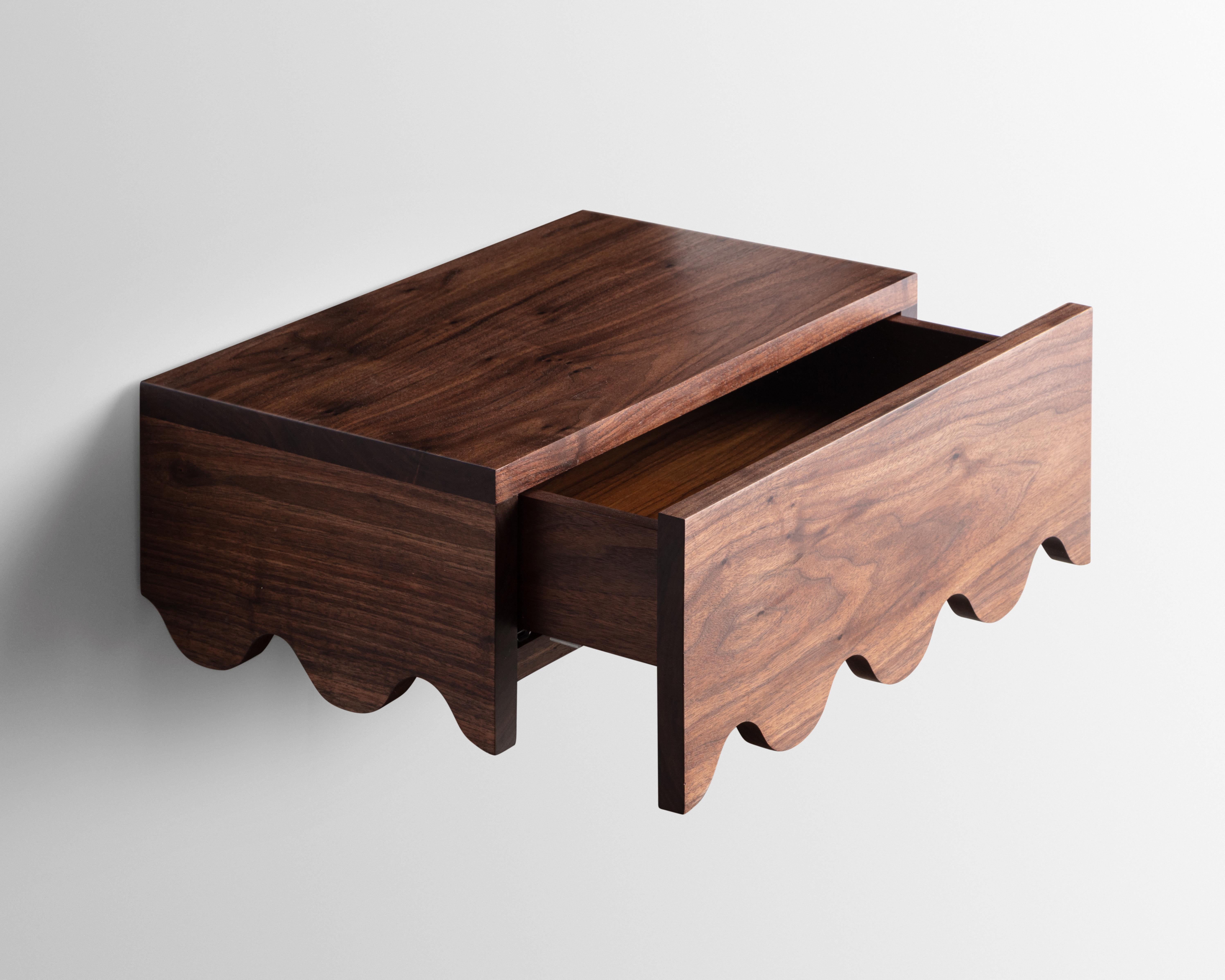 Designed and built in the studio the Squiggle floating nightstand table features a playful detail that continues along its sides and drawer face.

Made from solid Walnut -inspired by the French Mid-century designer Jean Royère.
 