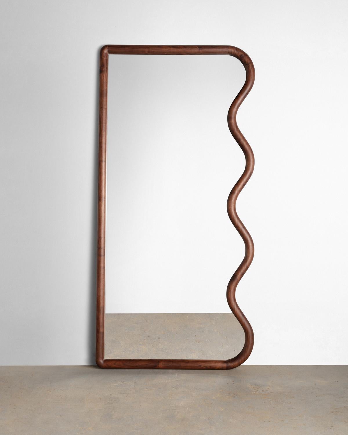 Constructed from Solid American Black Walnut this full-length squiggle mirror is sure to brighten up and space- All parts are hand sculpted from solid slab lumber.

Mirror can be placed leaning or we can supply custom hardware to hang vertically or