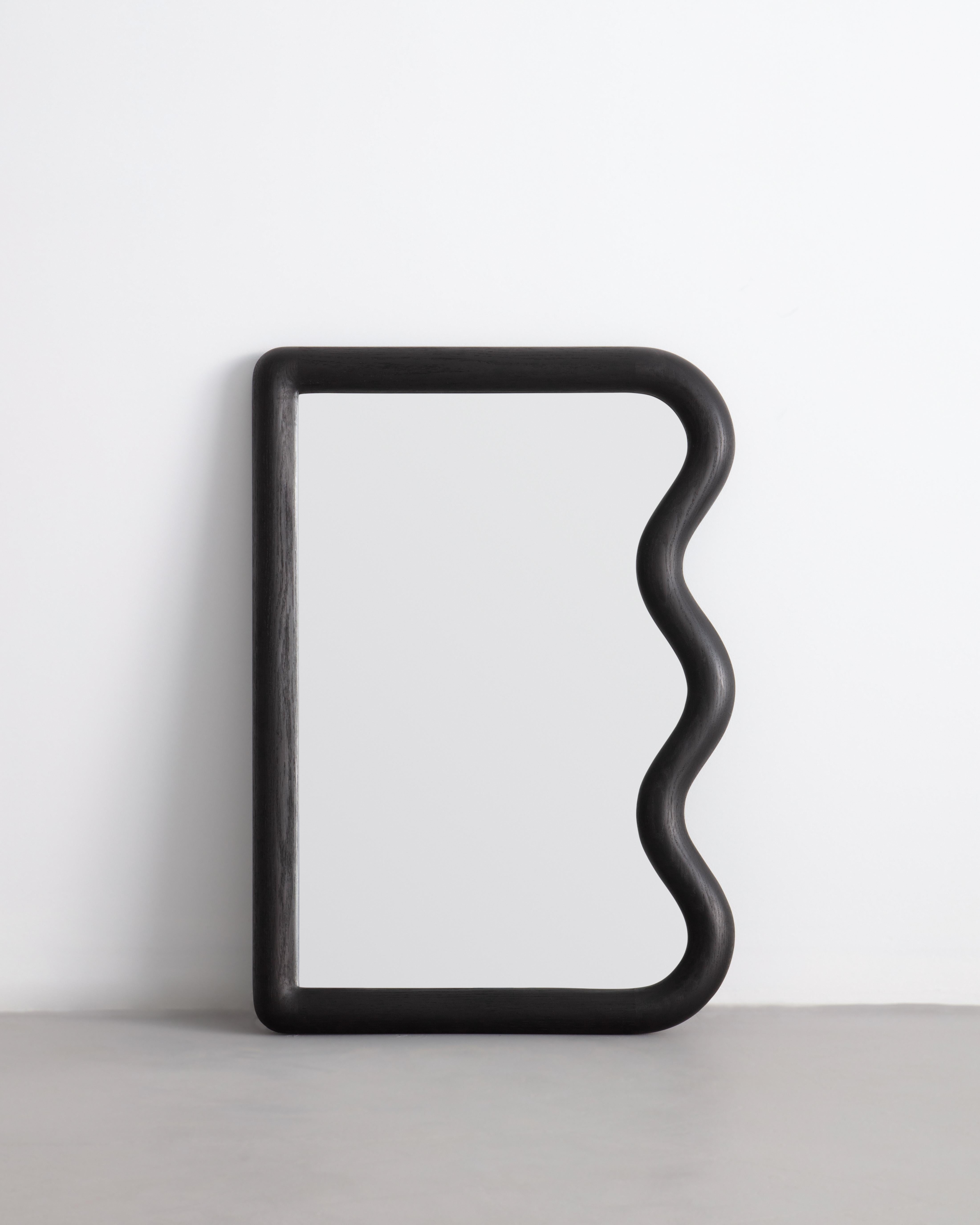 Constructed from solid charred oak this mini Squiggle mirror is made to order. The mirror can be hung vertically by its custom french cleat.

Mirror can be placed leaning or hung.