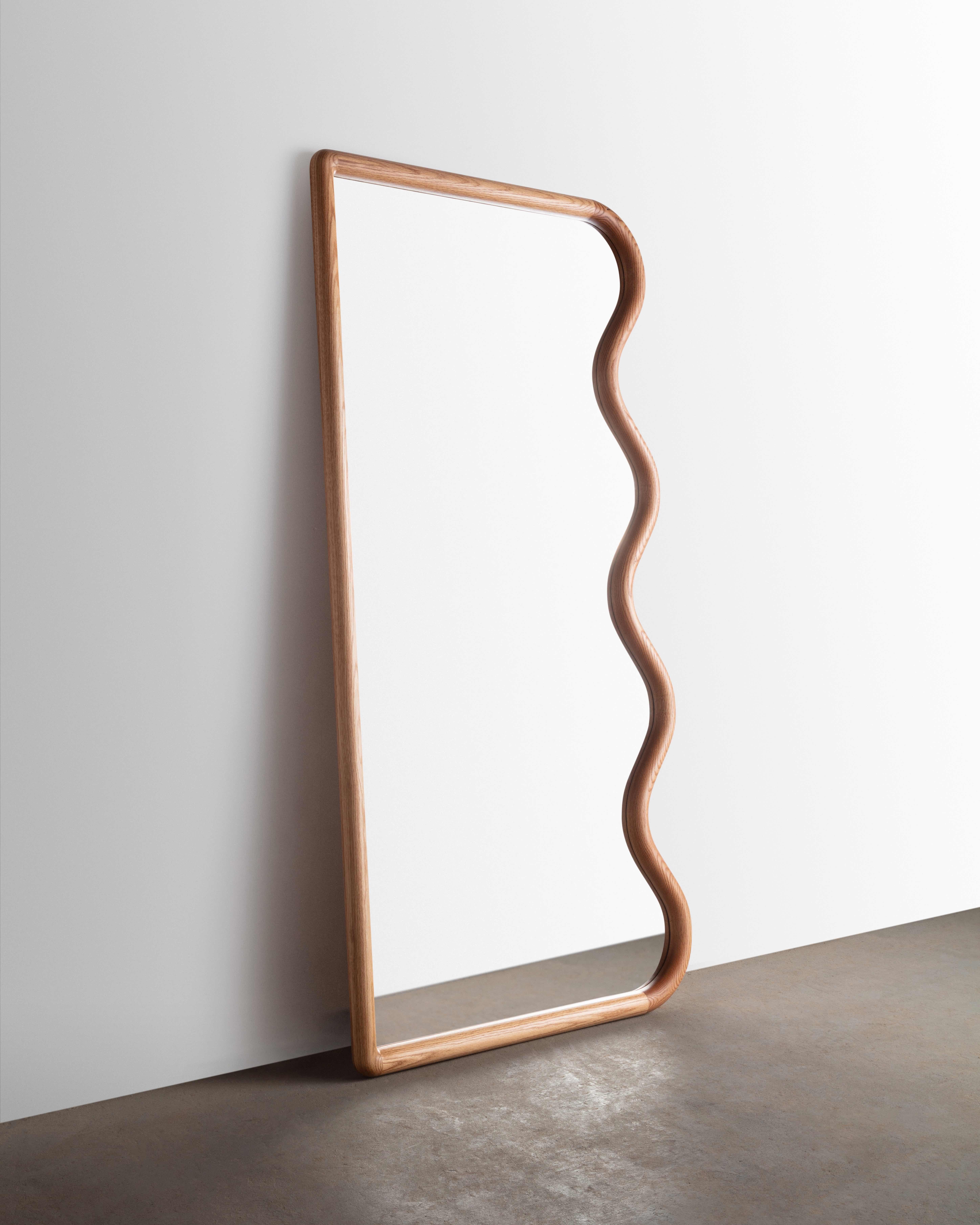 Constructed from Solid Red Oak this full-length squiggle mirror is sure to brighten up and space- All parts are hand sculpted from solid slab lumber.

Mirror can be placed leaning or we can supply custom hardware to hang vertically or horizontally