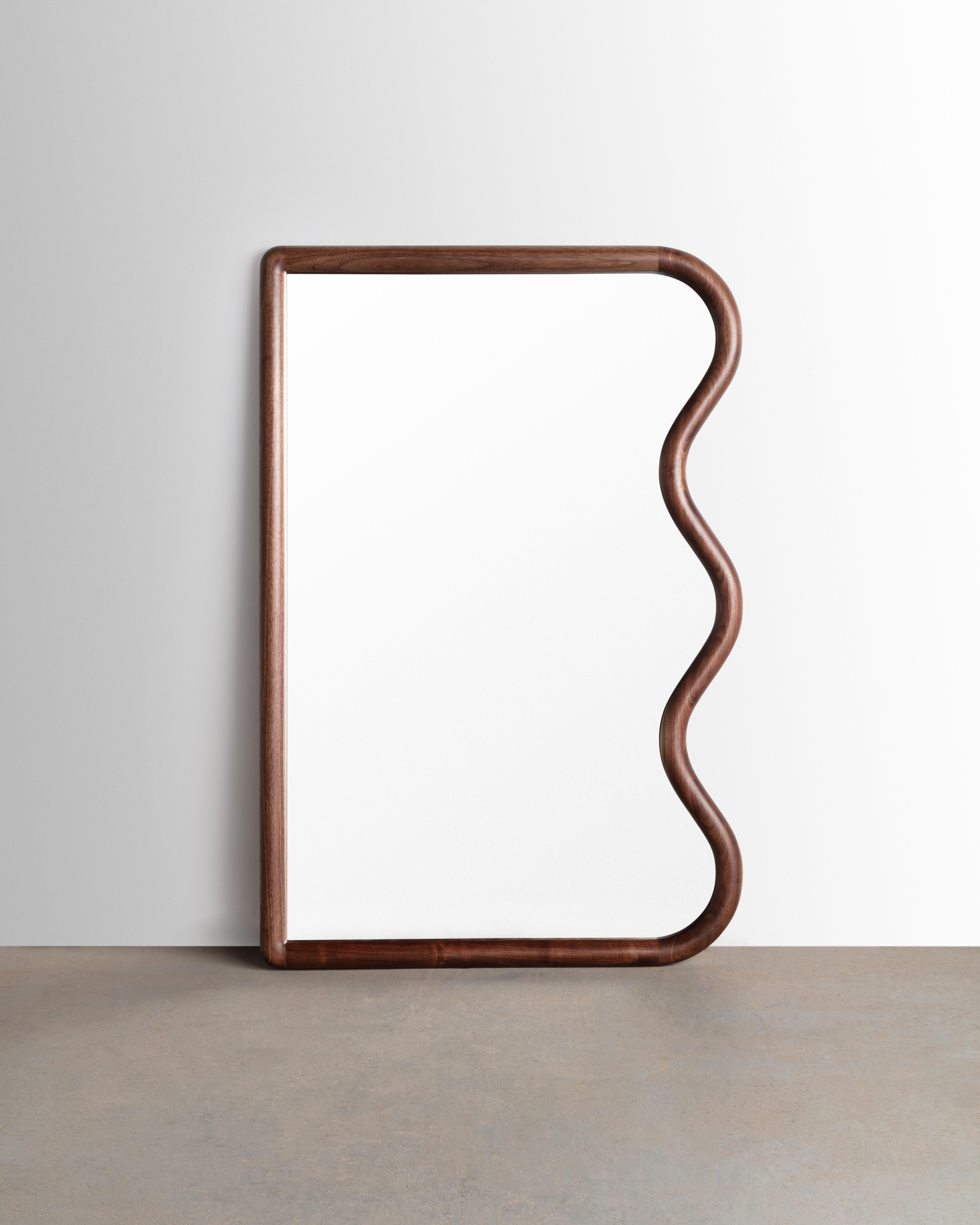Constructed from Solid American black walnut this squiggle mirror is made to order. Each part is hand sculpted from solid slab lumber and is sure to bring a smile to any space.

Mirror can be placed leaning or we can supply custom hardware to hang