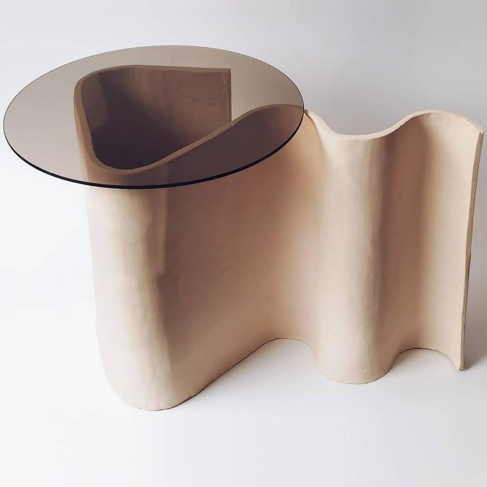 Squiggle side table by Jan Ernst
Dimensions: L 58 W 35 H 46 cm
Glass size: D 45 cm 
Materials: Unglazed white stoneware

Jan Ernst’s work takes on an experimental approach, as he prefers making bespoke pieces by hand. His organic design stems