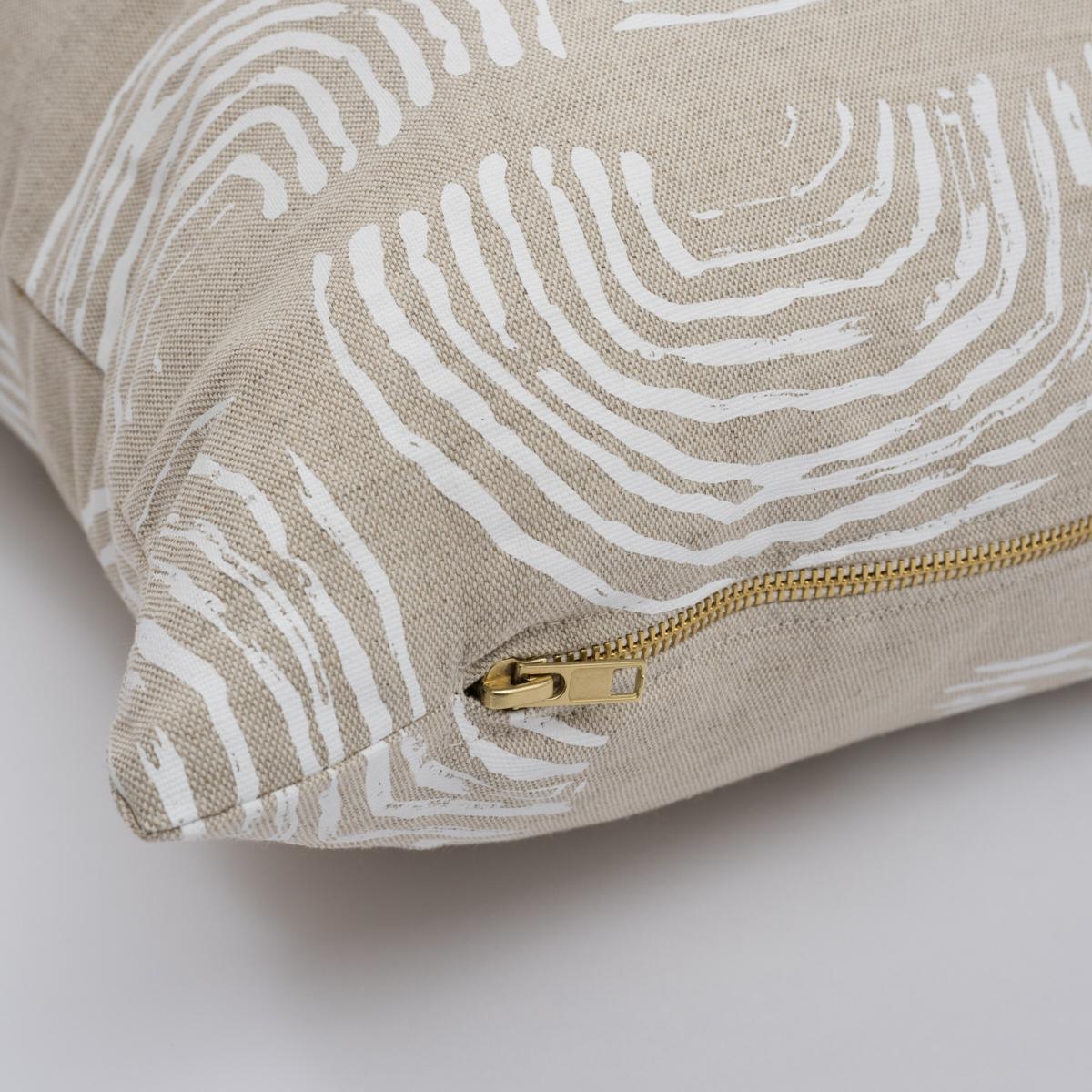 This pillow features Squiggles by Caroline Z Hurley with a knife edge finish. The repeated rainbow-shaped curves of this ivory-on-natural fabric's loose, painterly pattern are printed on a linen-cotton-blend fabric. Pillow includes a feather/down