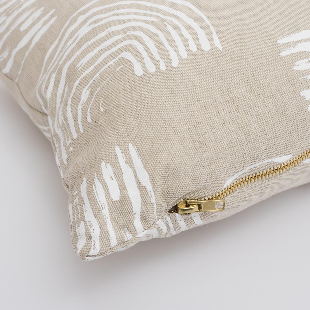 This pillow features Squiggles by Caroline Z Hurley with a knife edge finish. The repeated rainbow-shaped curves of this ivory-on-natural fabric's loose, painterly pattern are printed on a linen-cotton-blend fabric. Pillow includes a feather/down