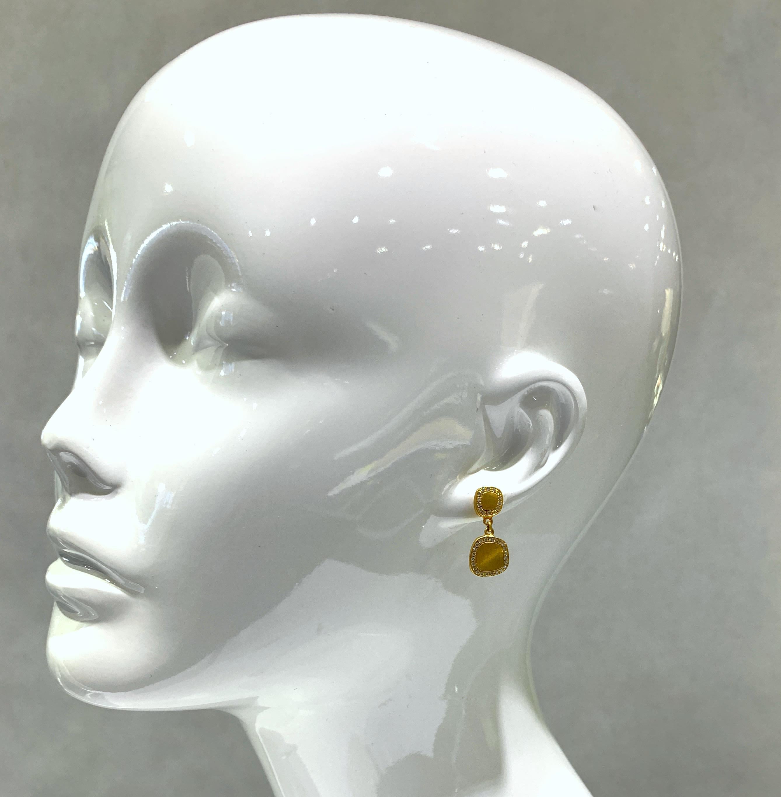 Eytan Brandes used one of his favorite motifs -- the rounded, irregular square -- for these charming handmade two-piece drop earrings in rich 18 karat yellow gold.  Each plate has a lustrous satin finish and is bordered in tiny, pavé-set