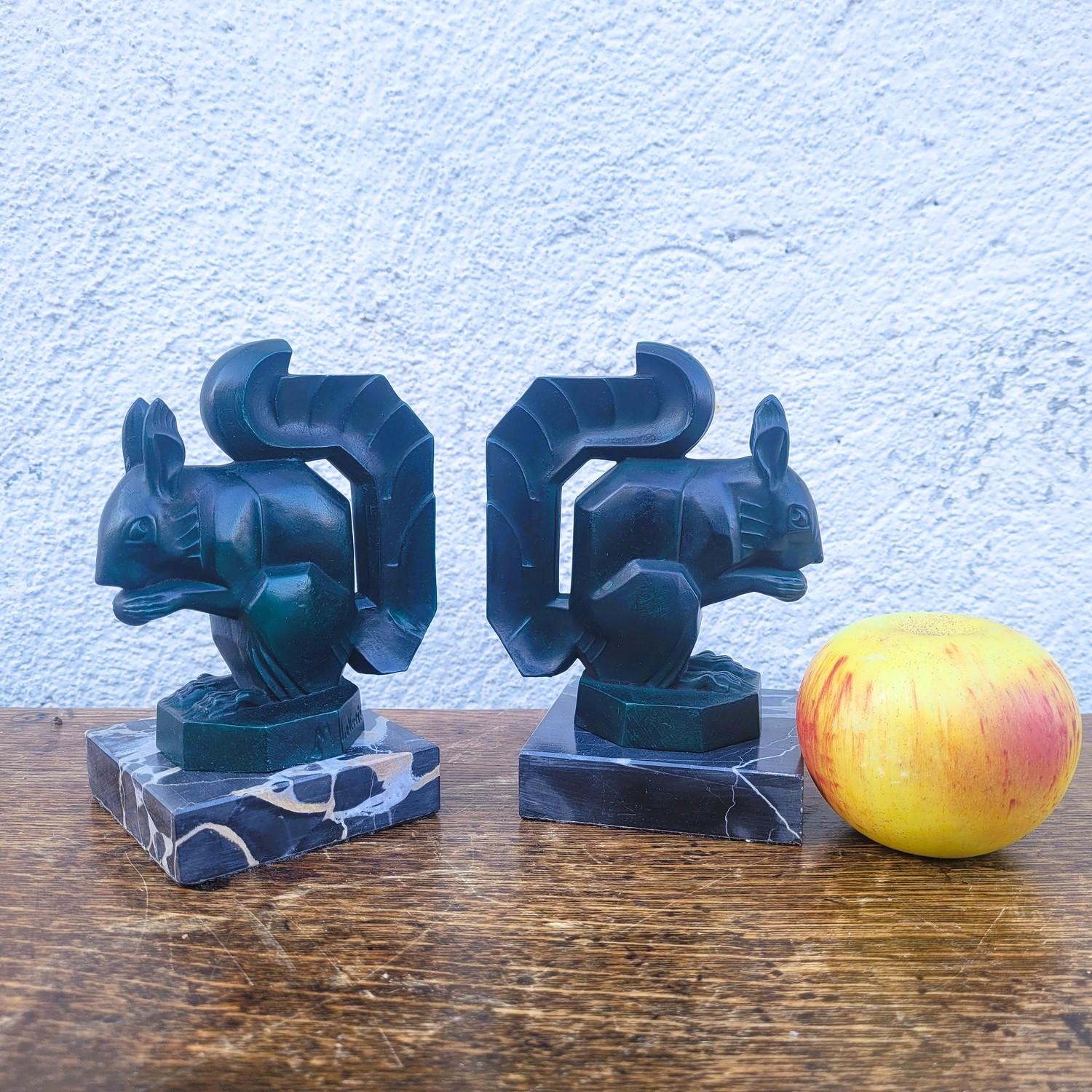 Pair of squirrel bookends, in green metal (spelter) on a marble base.  

 Both are signed Max le Verrier.  

 Good overall condition - very minor chips to the marble.   


Height 15 cm,
 10 x 8.5 cm.