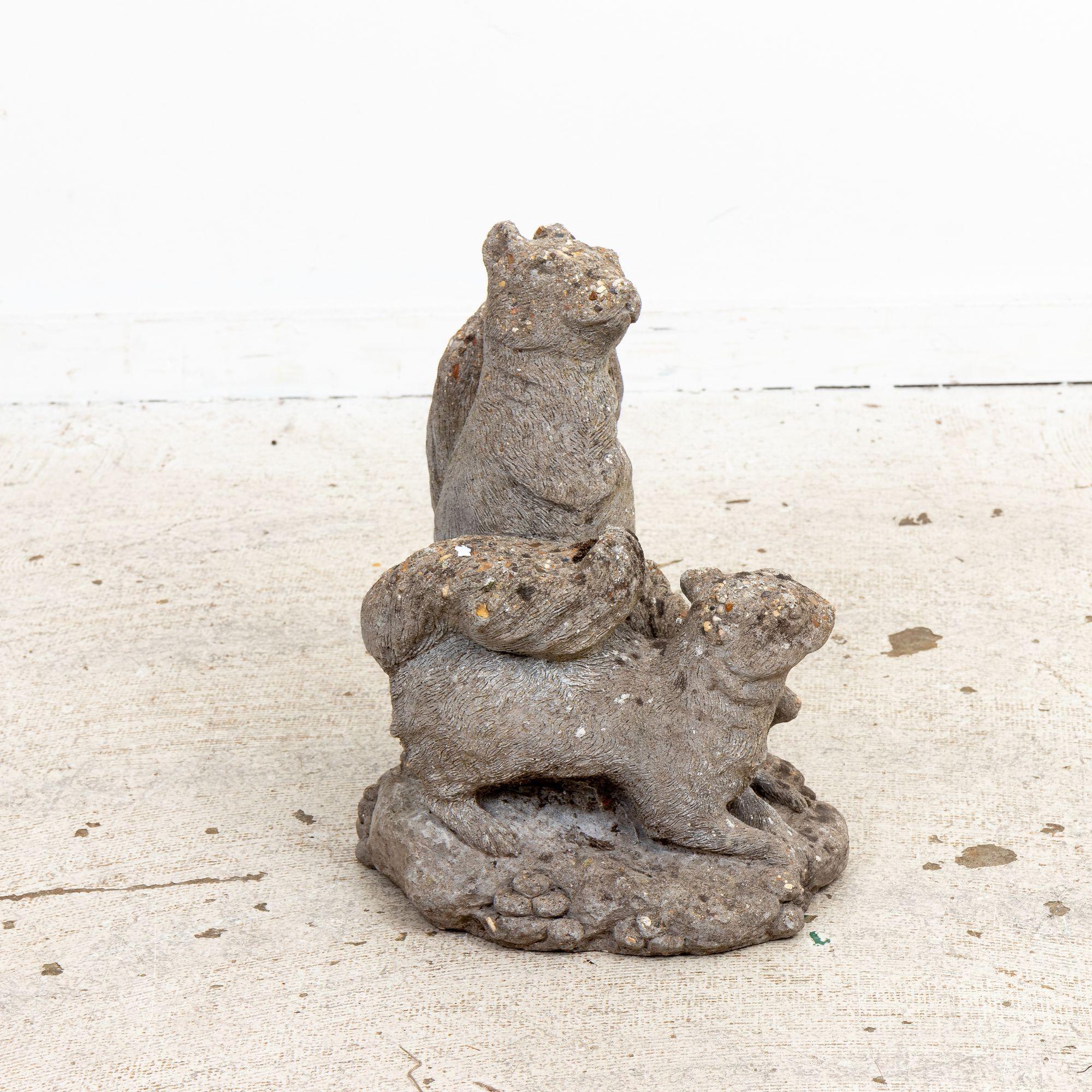 This remarkable mid-20th century Belgian garden ornament captures the essence of a playful family of squirrels. Meticulously crafted from durable concrete, these lifelike sculptures showcase intricate details, from the bushy tails that seem ready to