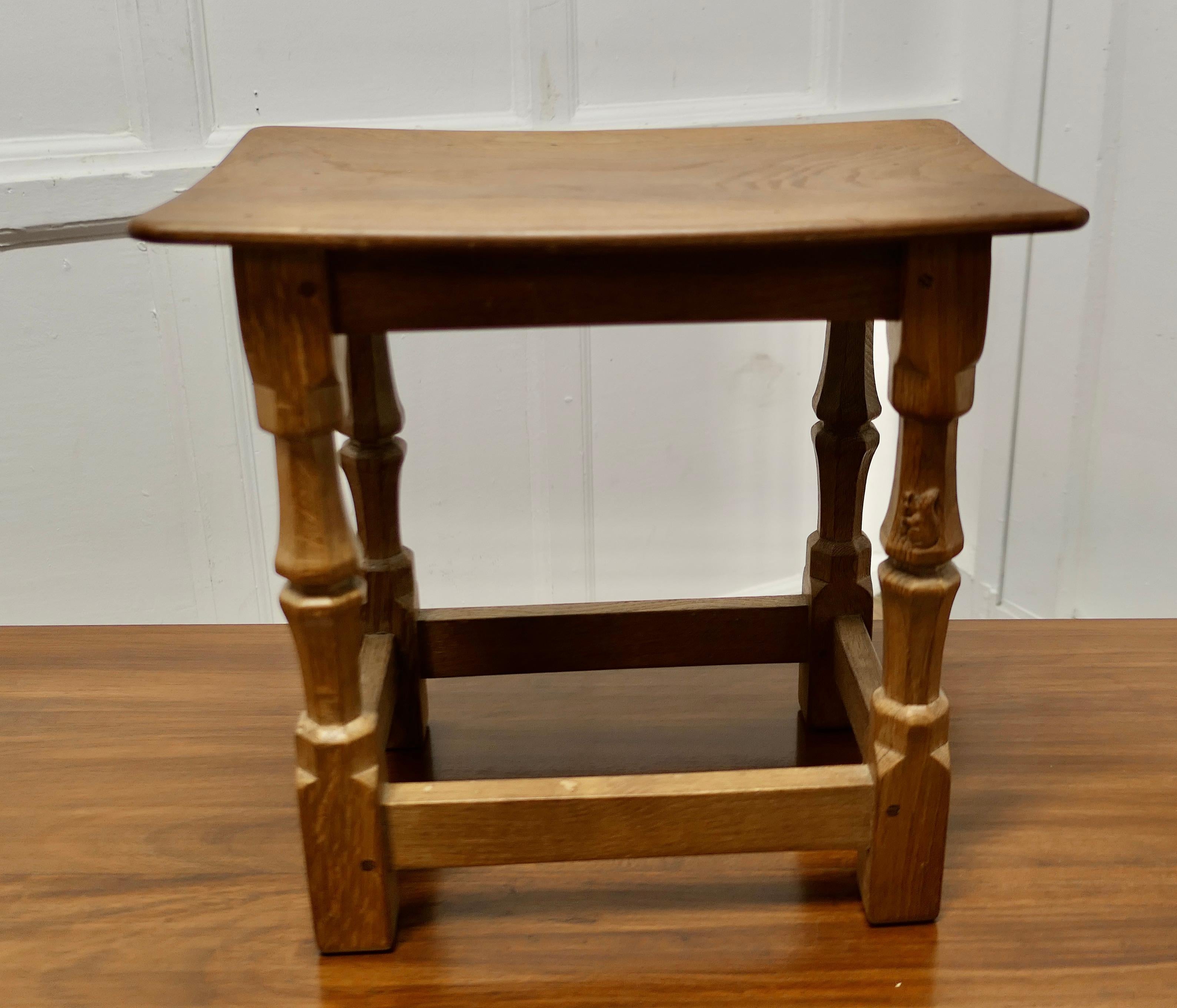 Squirrelman Oak Dish Top Adzed Stool by Wilf Hutchinson  
A Squirrelman Oak Joined Stool by Wilf Hutchinson with a raised prominent carved squirrel with a one piece adzed, shaped oak top set on four turned and octagonal shaped legs one with the