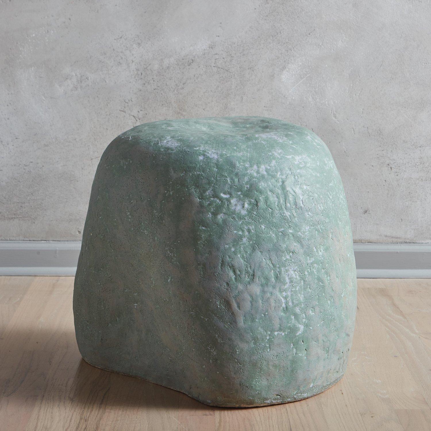 A ceramic Squish stool by Yuko Nishikawa in pine.

Squish Stools form a continuous body together with each ceramic stool squishing and being squished by other stools. They were created during the pandemic in 2020, a time in which touch and