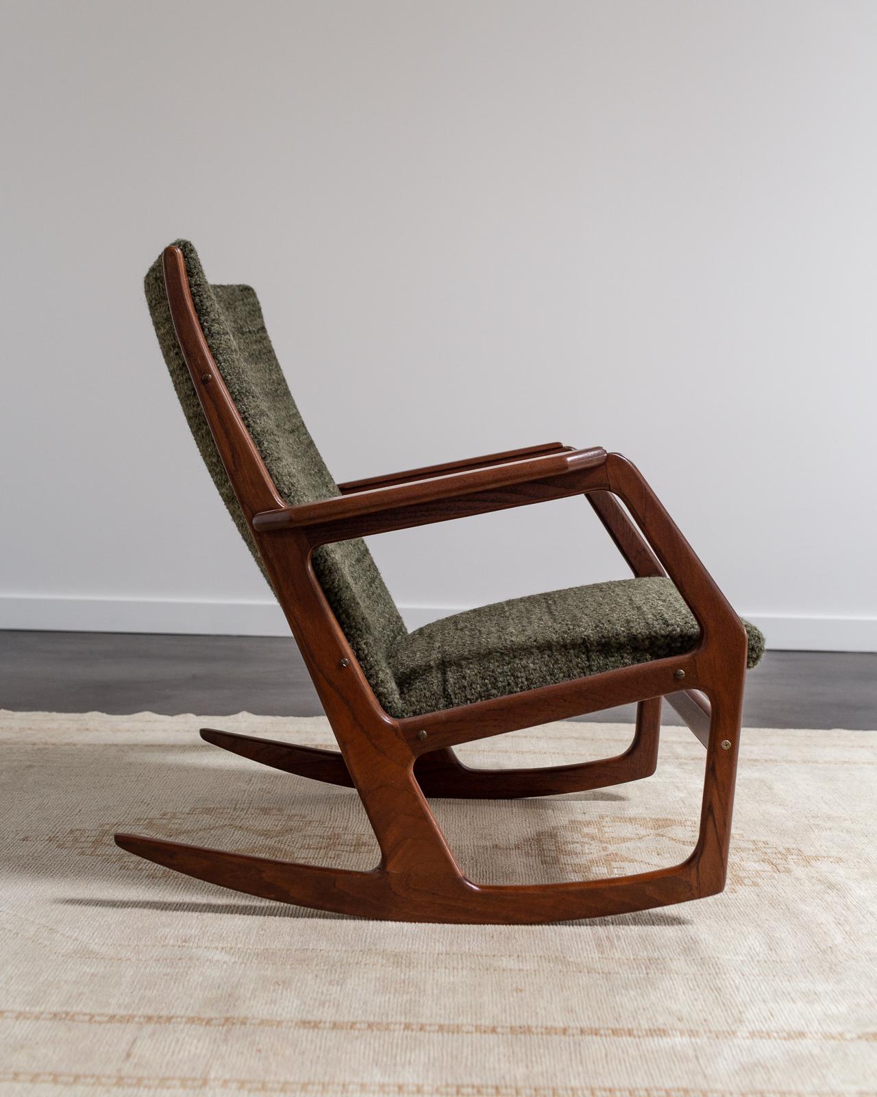 This danish rocking chair by Søren Georg Jensen is constructed with a teak frame and sculpted arms. Newly refinished and reupholstered in a Rosemary Hallgarten Alpaca.