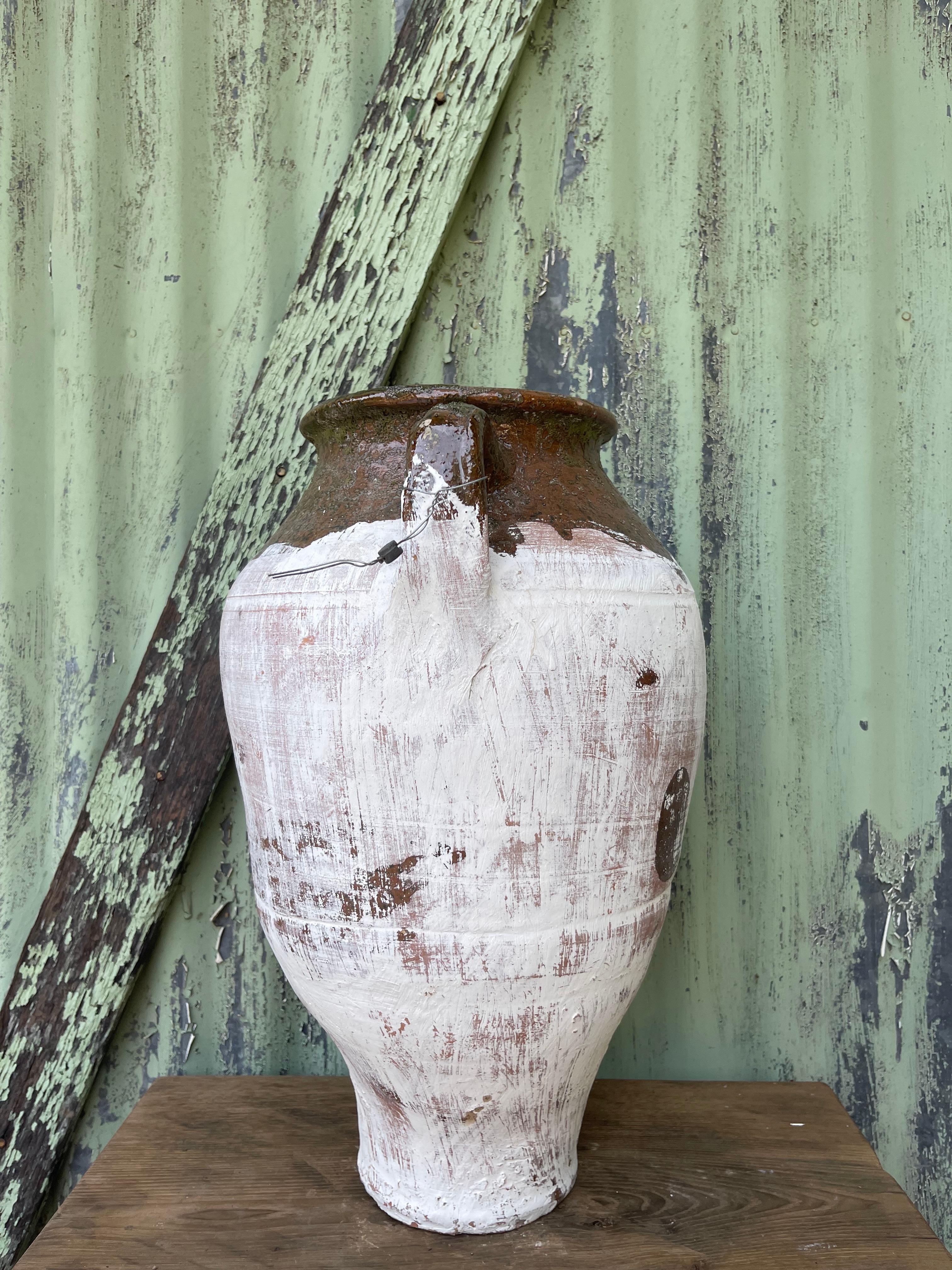 This medium glazed and limewashed küp was likely used to store cheese by generations of families in the Levant. The design is similar to jugs used to carry water, wine, or other liquids (as cheese is traditionally stored in its brine). Glazing and