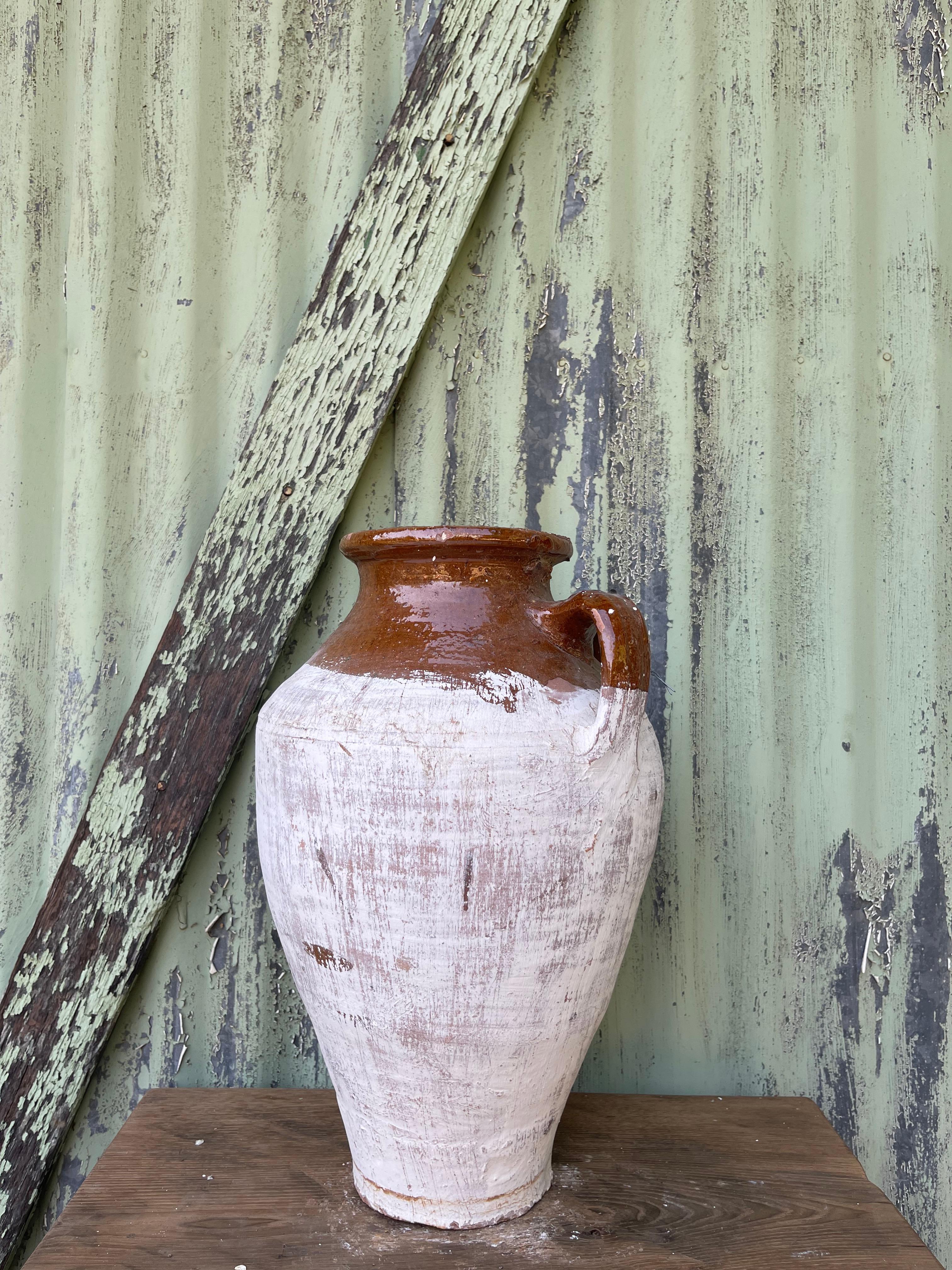This medium glazed and limewashed küp was likely used to store cheese by generations of families in the Levant. The design is similar to jugs used to carry water, wine, or other liquids (as cheese is traditionally stored in its brine). Glazing and
