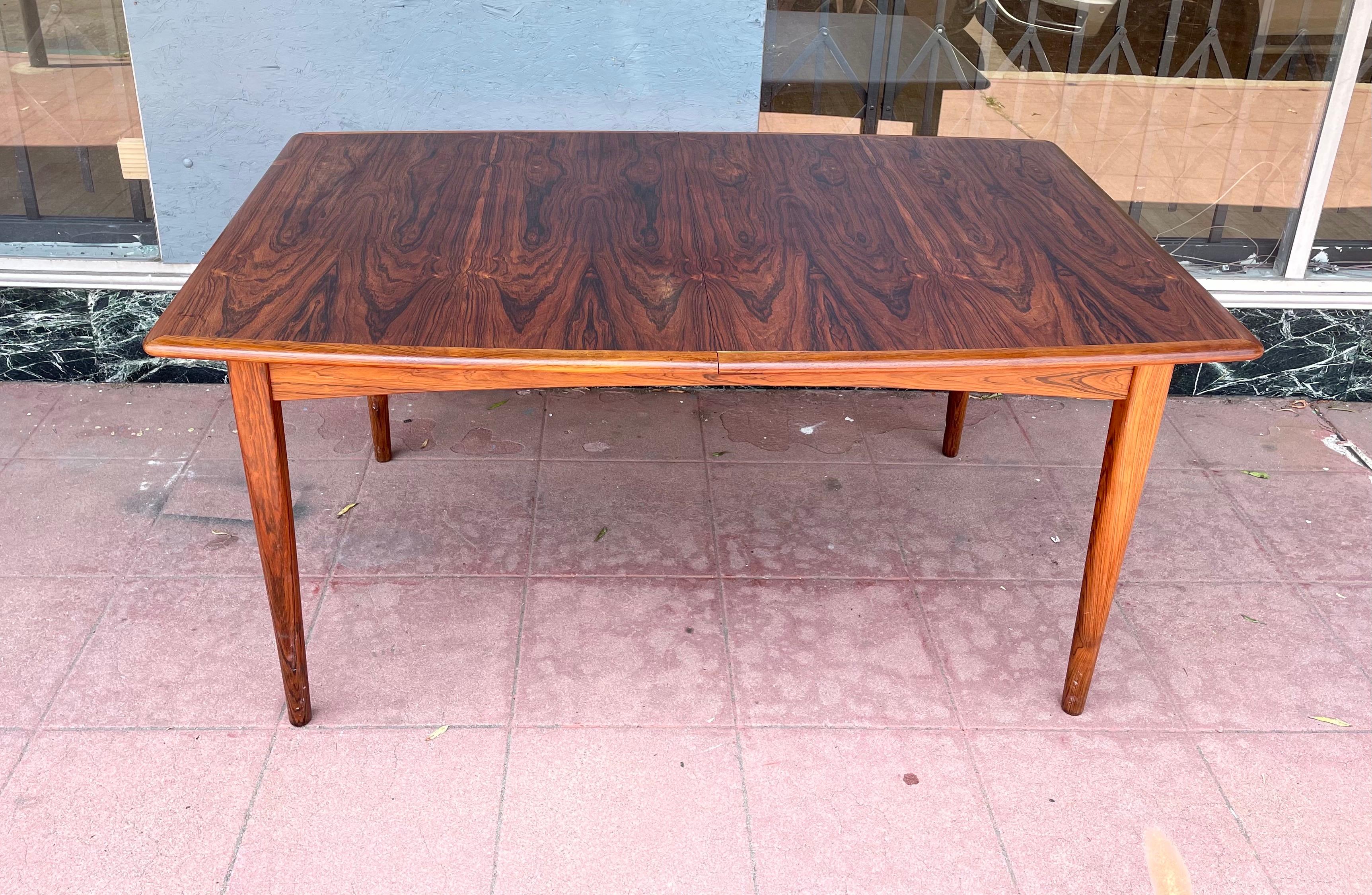 Beautiful X Large rosewood extendable dining table with butterfly leaves, Incredible system where each leaf hides under the table and folds, makes it easy for storage and only needs one person to adjust. solid and sturdy we have cleaned and oiled