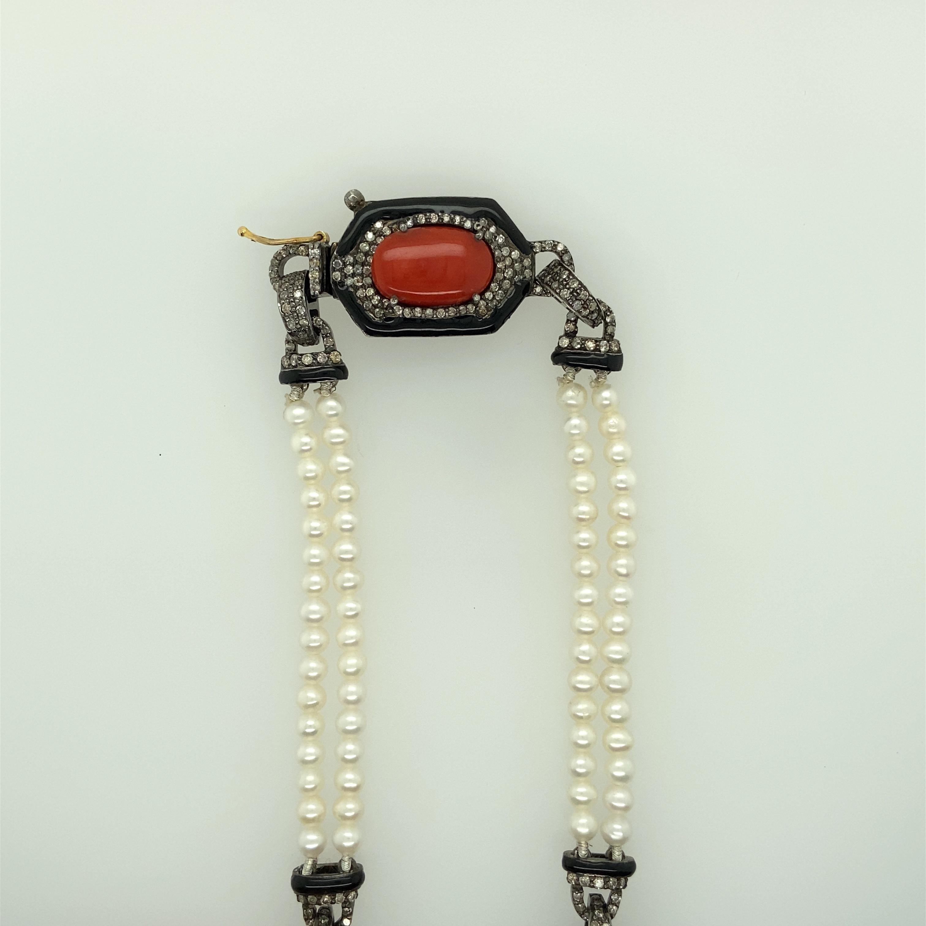 One Antiqued finished sterling silver and 14 karat yellow gold (stamped 925 14K) vintage necklace featuring eight oval shaped cabochon coral stones measuring 13x8.75, 15.5x9, 16x11, and 19x11.5.  The necklace also features approximately 4.0 carats
