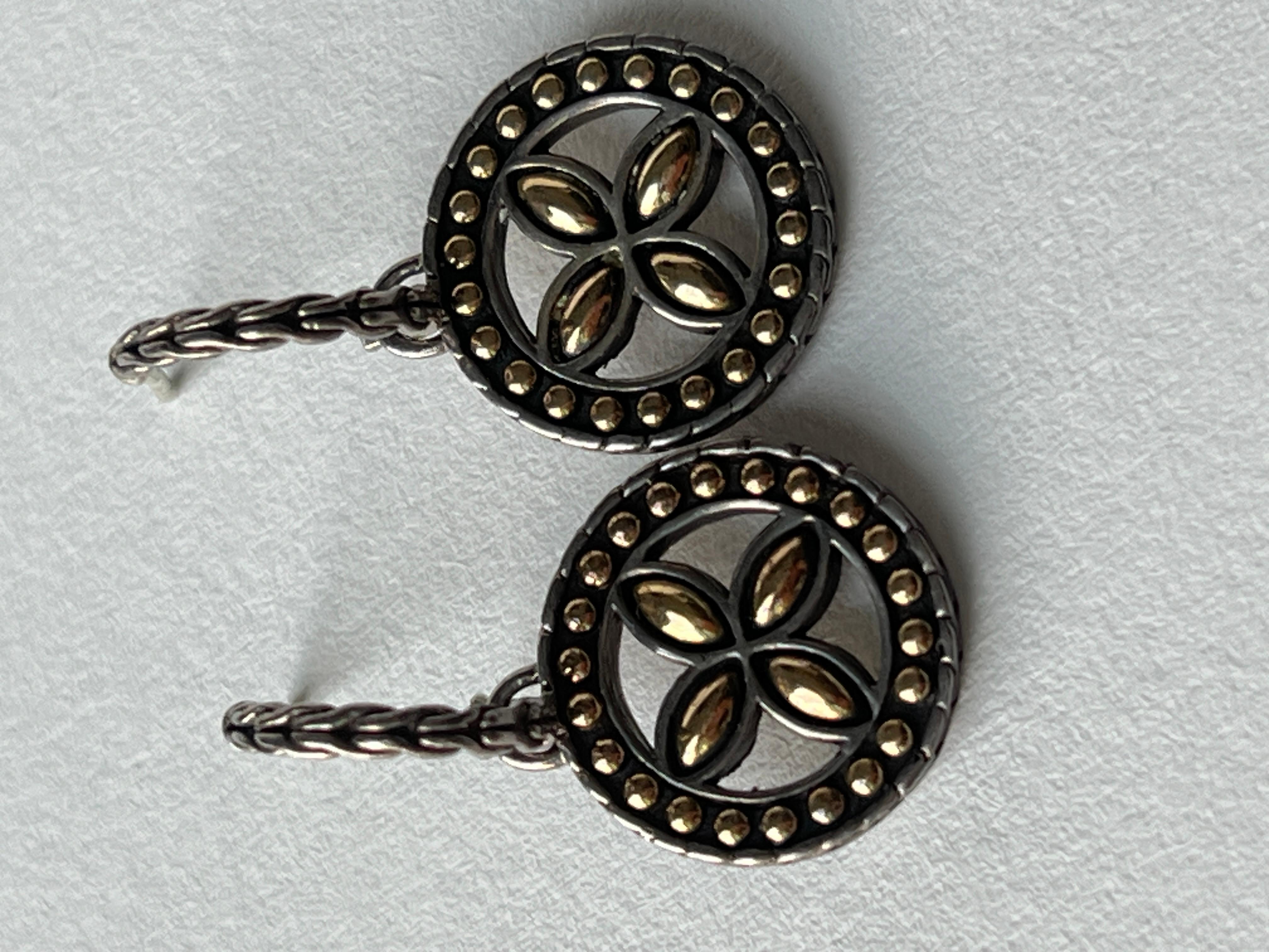 Unique hoops with a dot design made of solid sterling silver and 18K solid yellow gold by John hardy. The hoops have a rope design and close with butterfly style. The drop portion has a flower design with solid yellow gold. 
Solid feel,