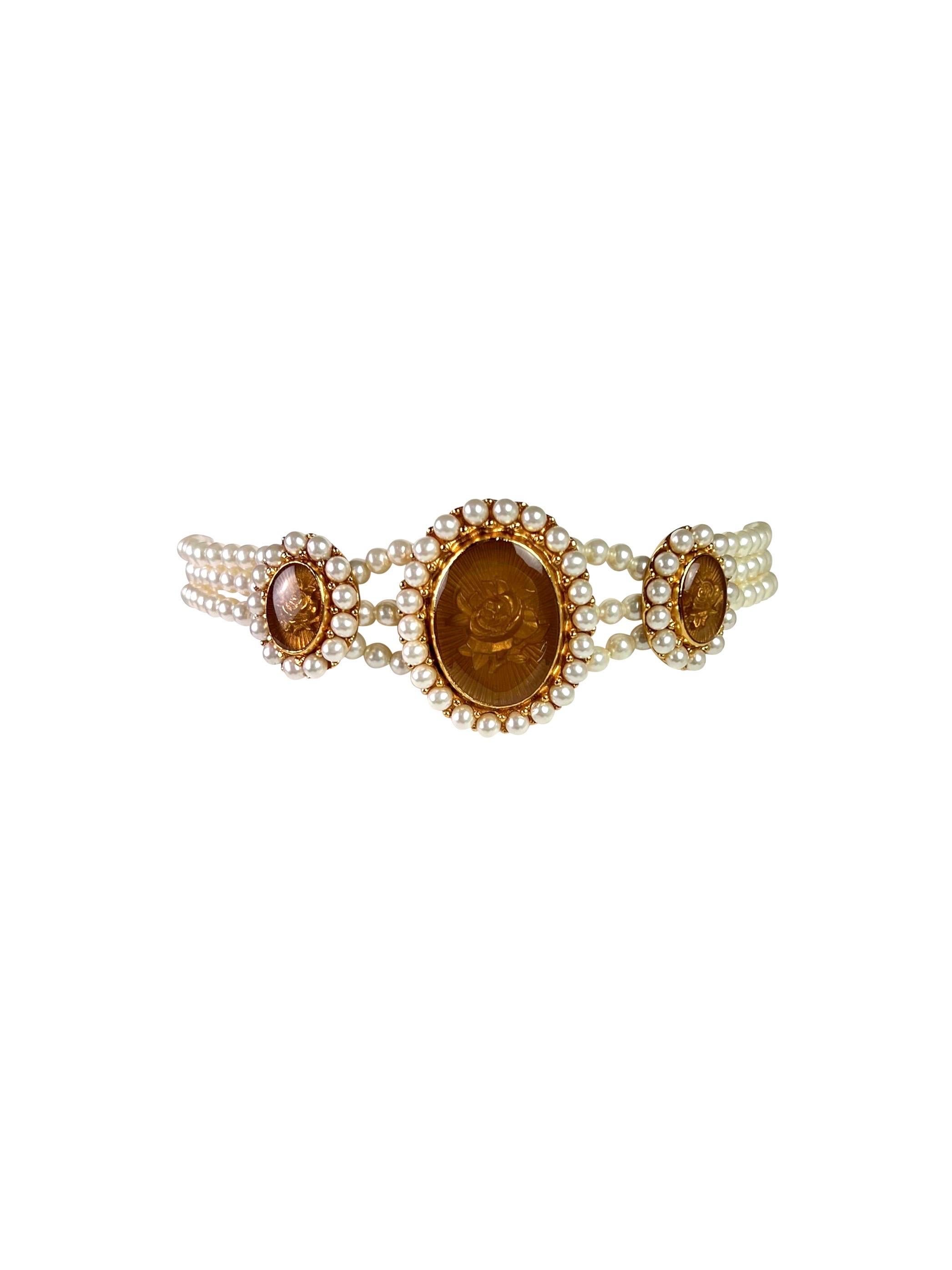 Absolutely beautiful and rare faux pearl choker with 3 Cameo-style gold-plated Charms with rose image under the glass.

Measurements:
Height - approx. 1,2 cm (0,5 inches), the height of a largest charm is 4 cm (1,6 inch)
Length - 29,5-35,5 cm