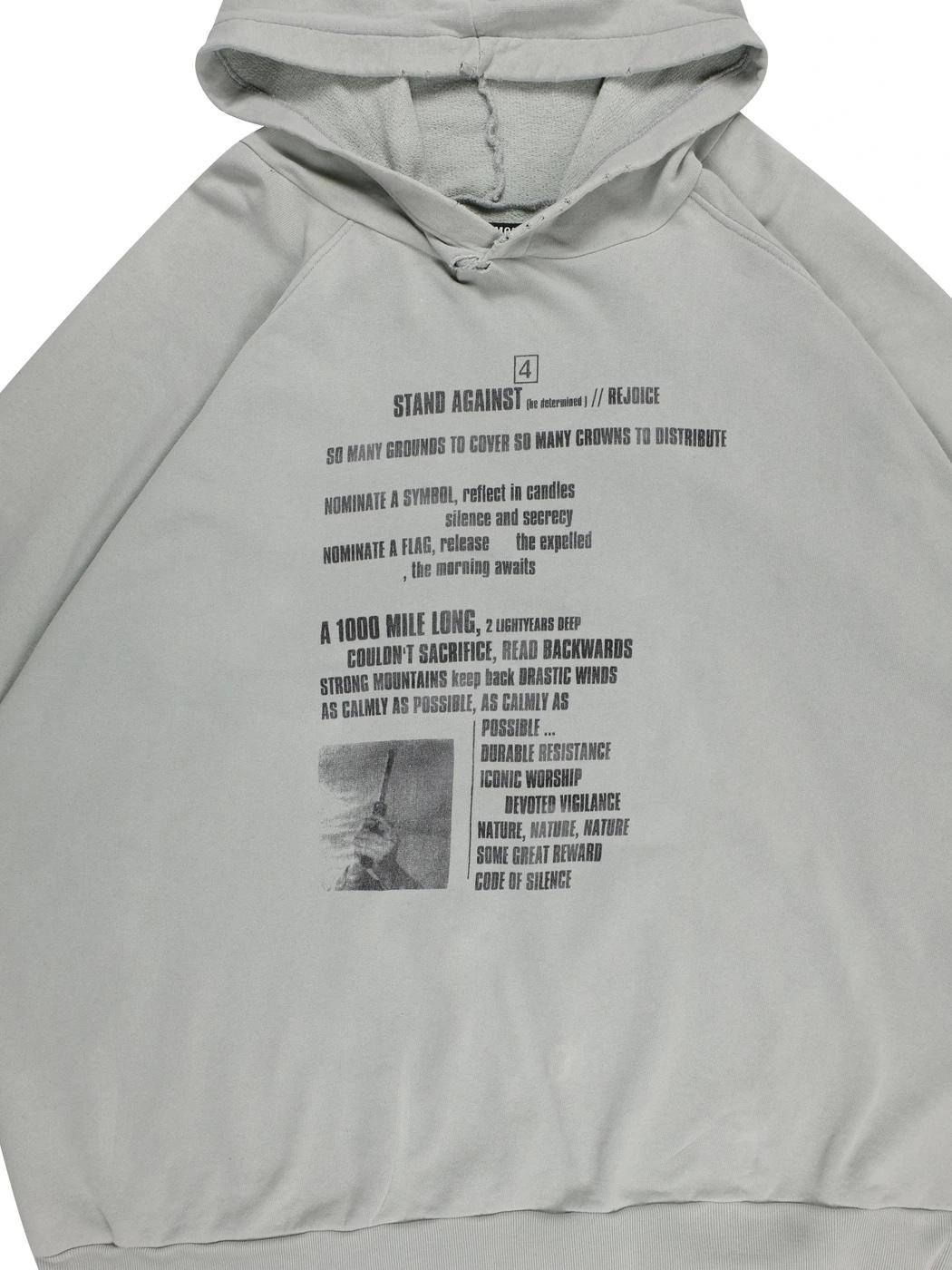 An extremely rare and legendary Terrorism hoodie from Raf Simons' SS02. This piece features ominous writing and haunting imagery on the front and back that was shown on the infamous show where Raf's models walked down the runway with masks and