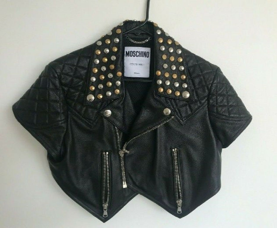 SS18 Moschino Couture Jeremy Scott Cropped Black Leather Biker Jacket W/studs

Additional Information:
Material: 100% Sheepskin Leather        
Color: Black/Silver/Gold
Pattern: Solid/Studs     
Style: Moto / Biker Jacket
Size: 40, 44 IT
Theme: