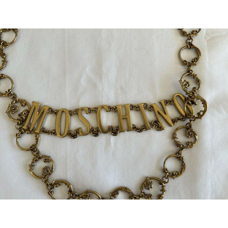 SS19 Moschino Couture Jeremy Scott Logo W/'shrubs on Metal Gate' Gold Dress Belt For Sale 1