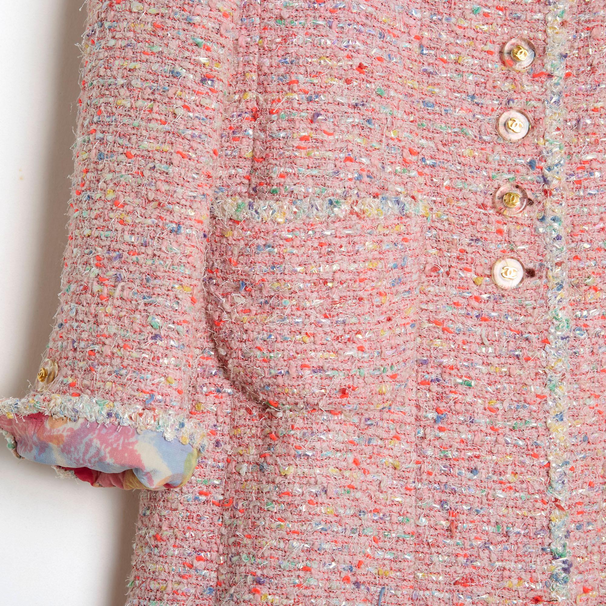 Chanel Spring Summer 1997 collection by Karl Lagerfeld composed of a pink wool and cotton blend tweed coat, notched collar closed with 6 CC logo buttons, 2 patch pockets on the hips, long sleeves with mini cuffs closed with a matching button, and a