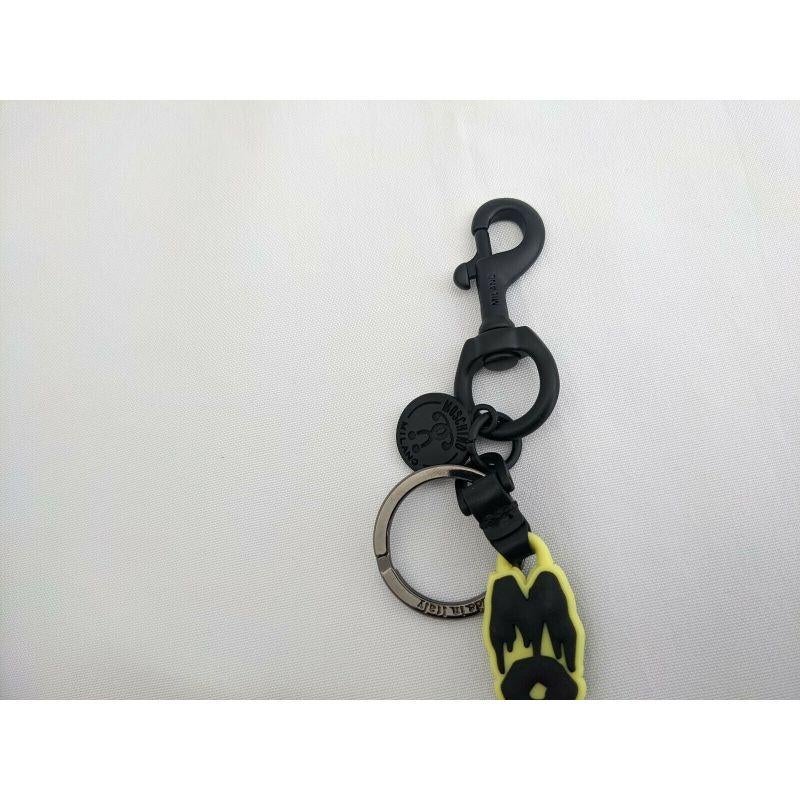Women's or Men's SS20 Moschino Couture Jeremy Scott Halloween Yellow Keychain Black Dripping Logo For Sale