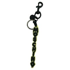 Moschino Couture - Porte-clés jaune Halloween avec logo noir « Dripping Logo » SS20