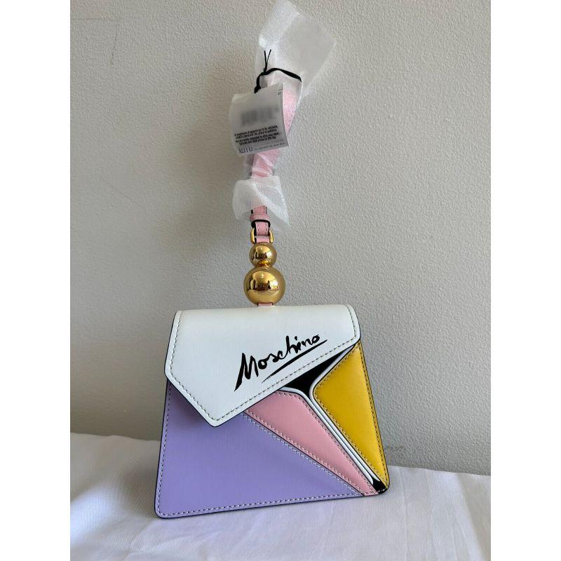 SS20 Moschino Couture Jeremy Scott Picasso Wristlet Handbag Pink Yellow Purple

Additional Information:
Material: Leather
Color: White, Pink, Purple, Yellow
Pattern: Geometrical
Style: Wristlet handbag
Size: Medium
Dimensions: 7