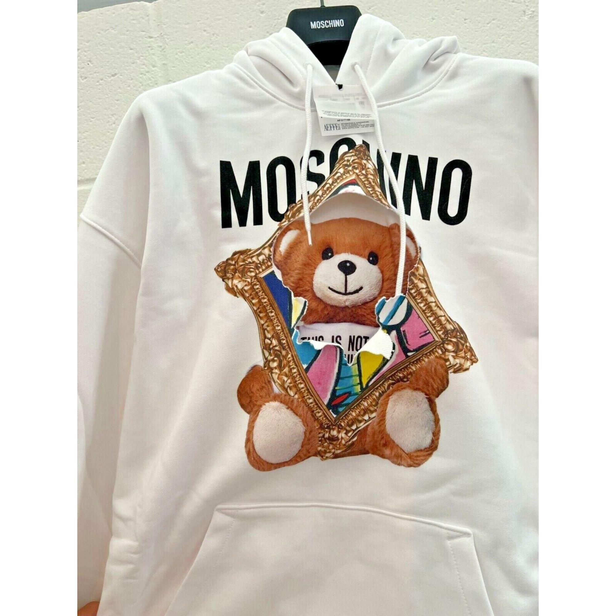 SS20 Moschino Couture Jeremy Scott Teddybear Bursting Thru Painting White Hoodie

Additional Information:
Material: 100% Cotton
Color: White
Size: IT 44 / US 10
Style: Pullover
Pattern: Logo, Teddy Bear, Painting
Dimensions: Shoulder to shoulder